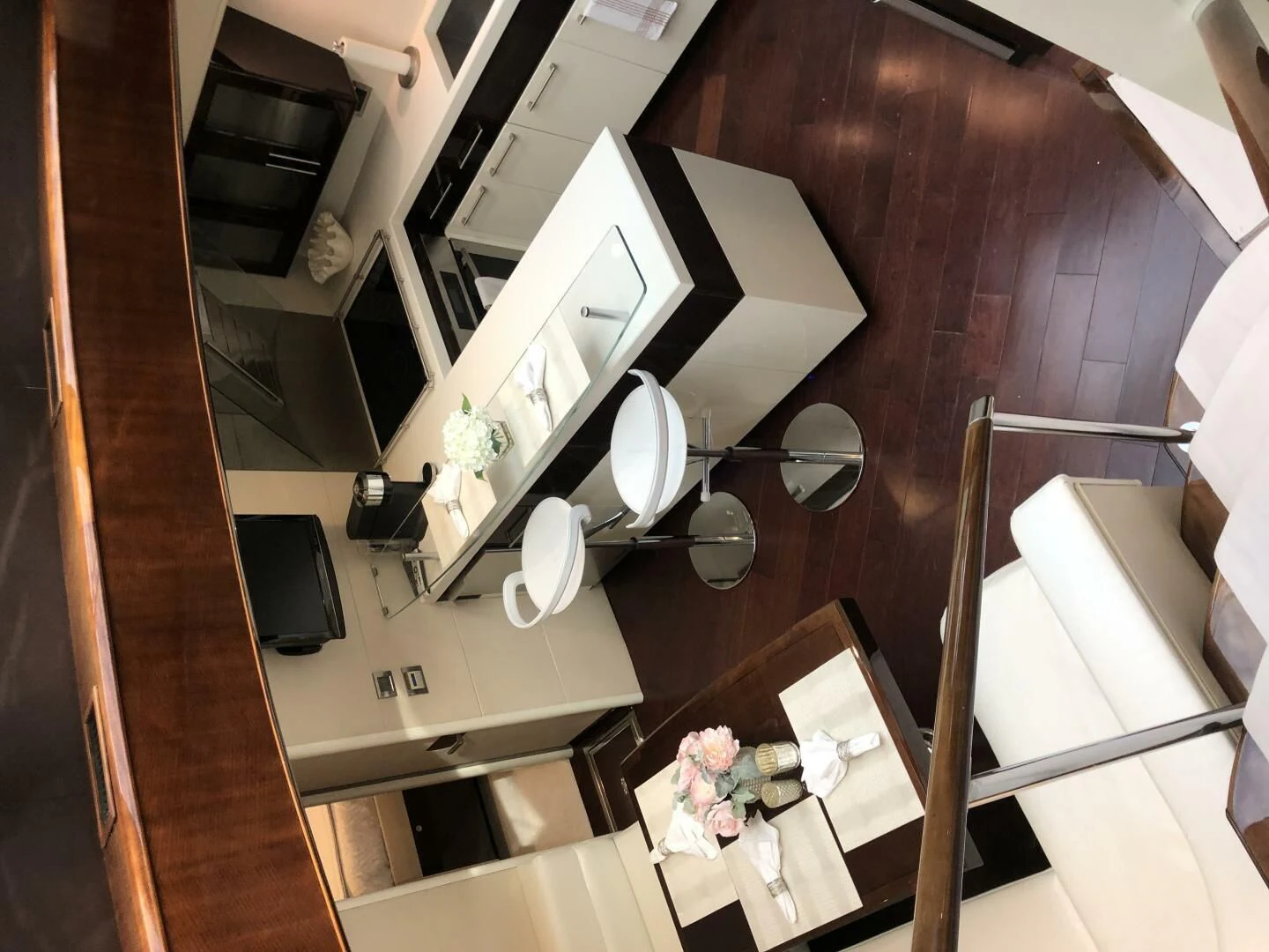 a white kitchen with a wood floor aboard BG Yacht for Sale