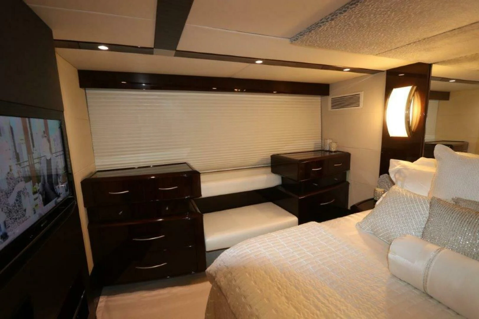 a bedroom with a bed and a television aboard BG Yacht for Sale