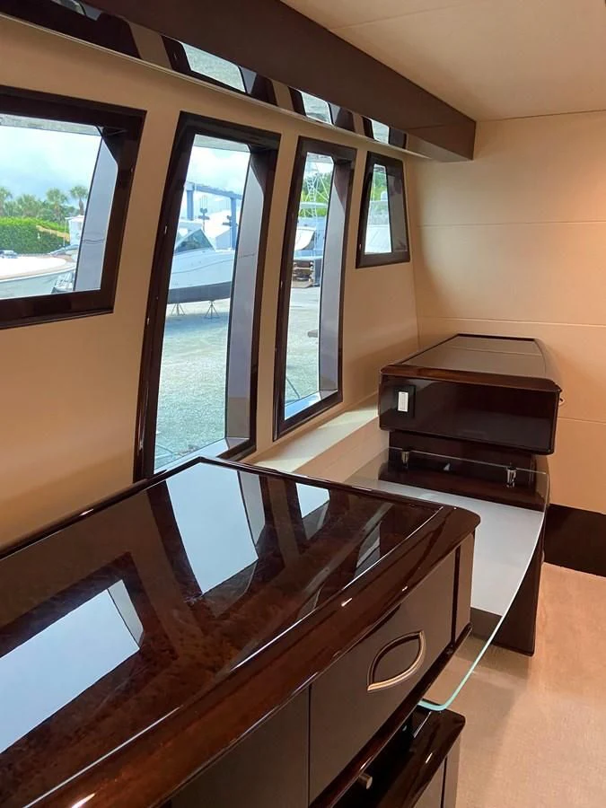 a room with a piano and a window aboard BG Yacht for Sale