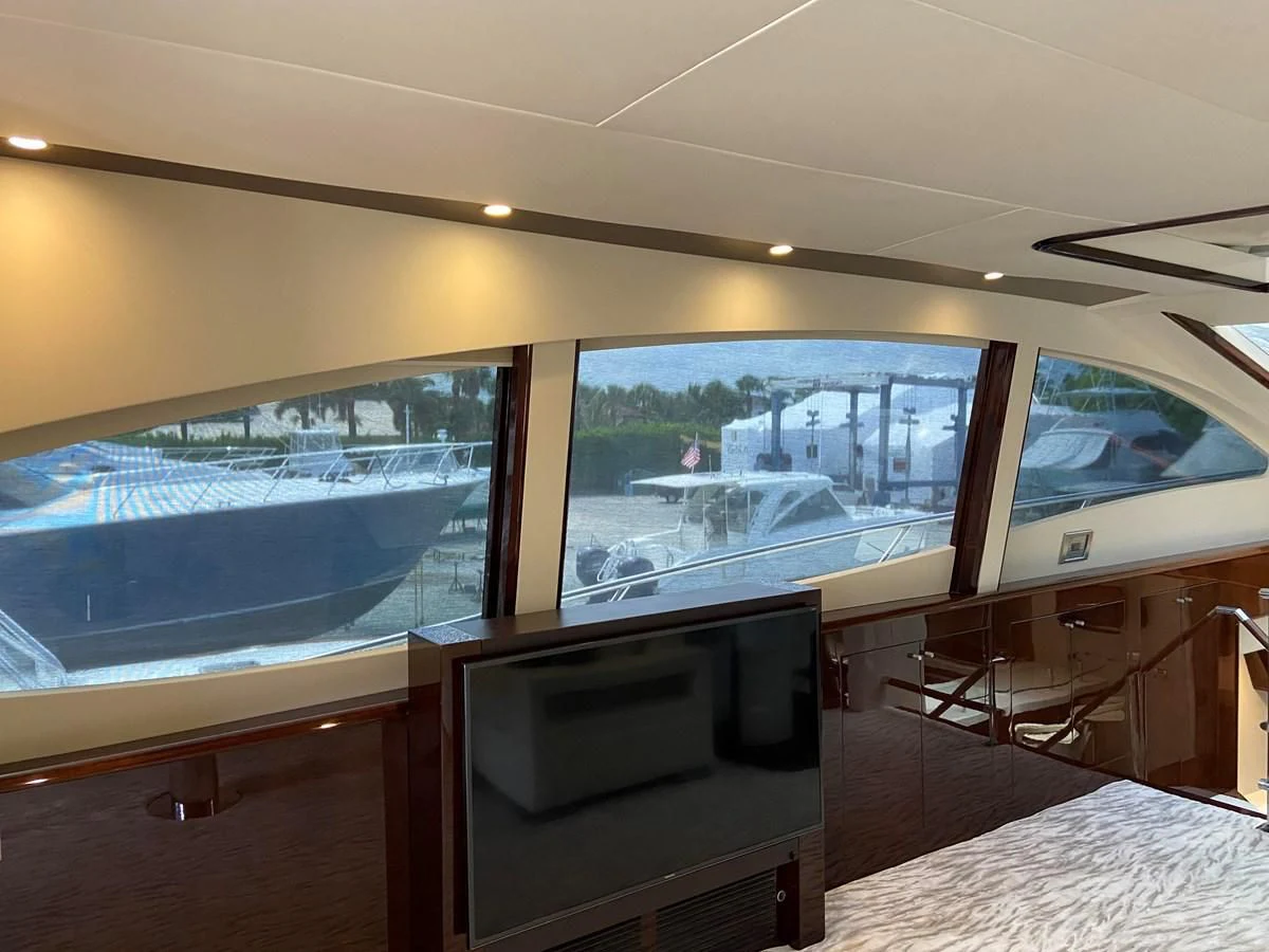 a room with a large window and a tv aboard BG Yacht for Sale