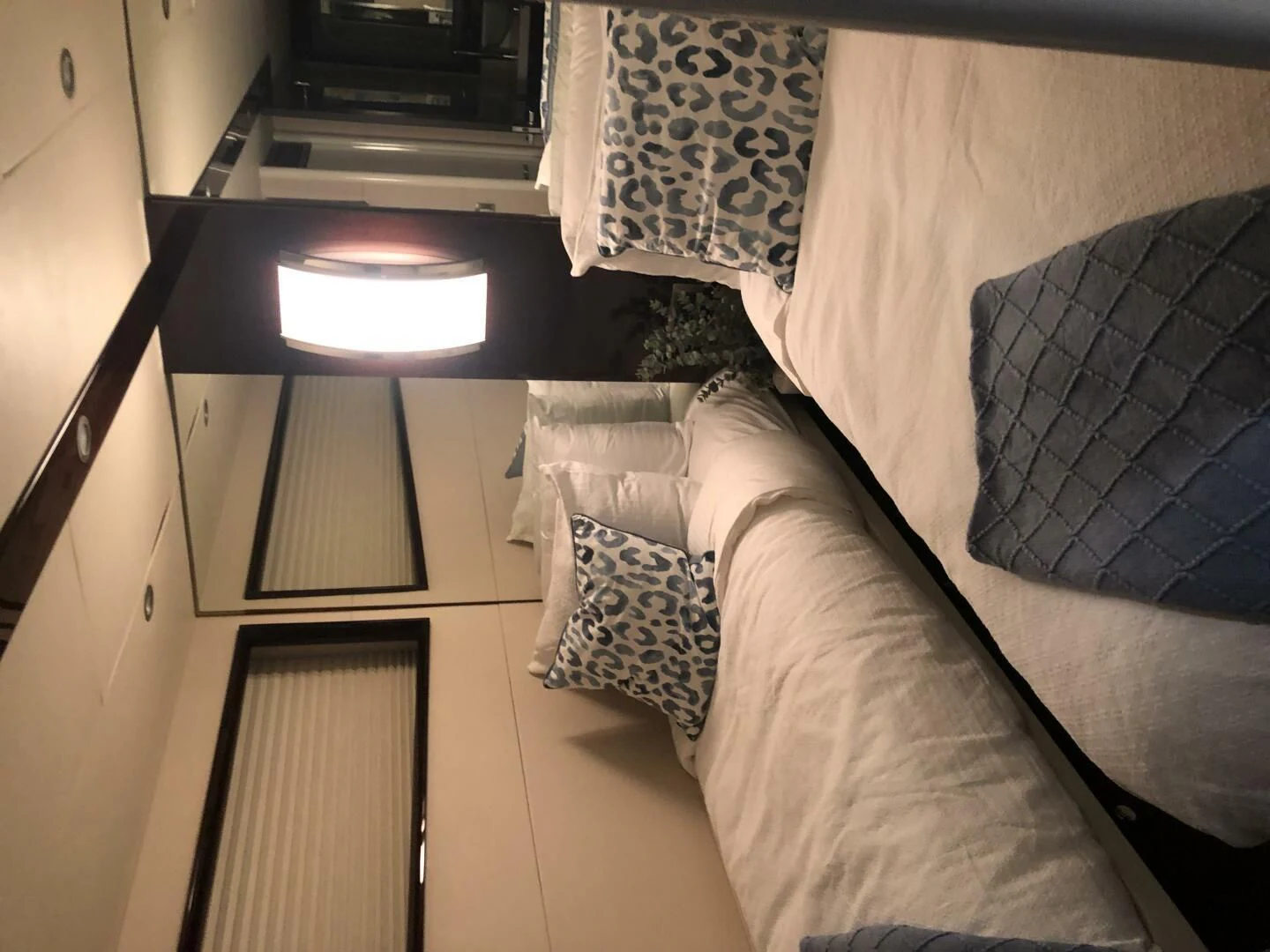 a bed with a television on the wall aboard BG Yacht for Sale