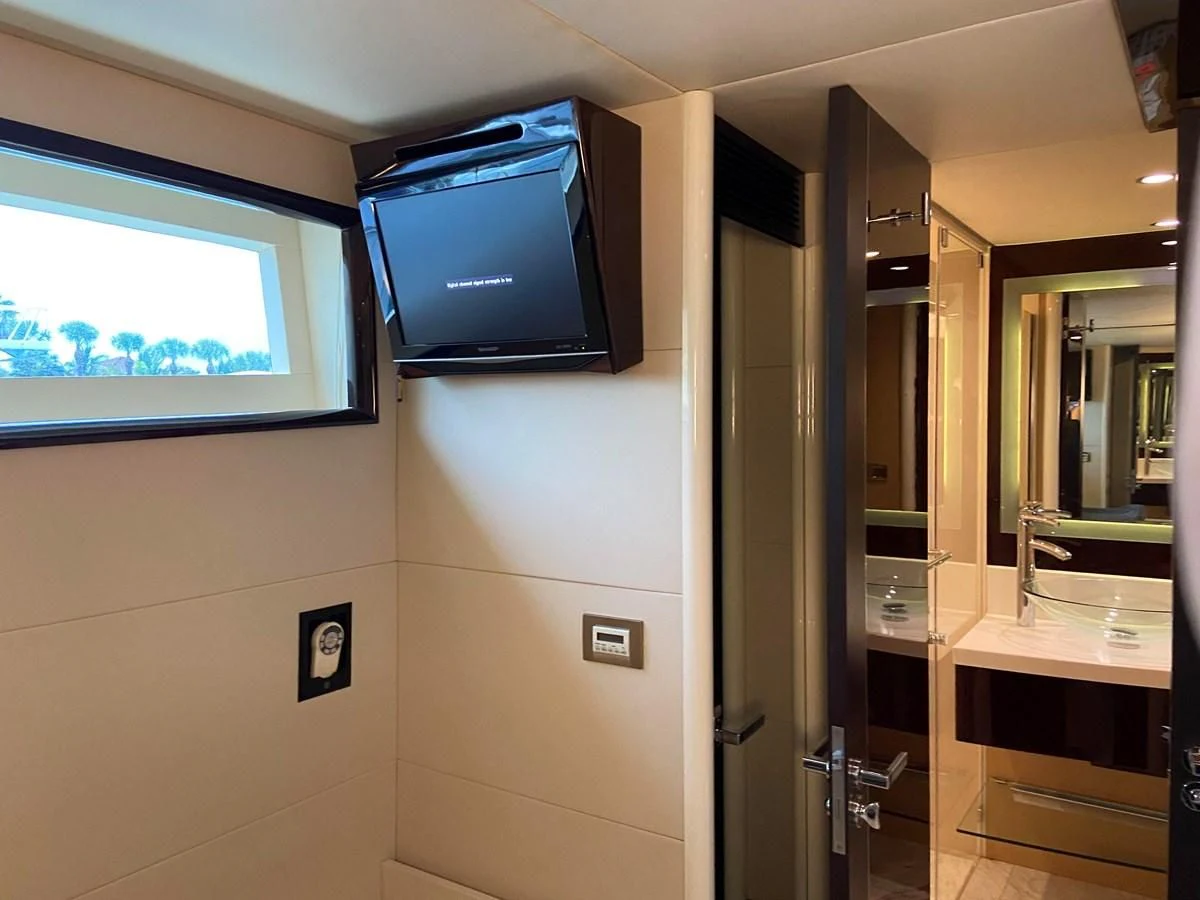 a room with a tv and a door aboard BG Yacht for Sale