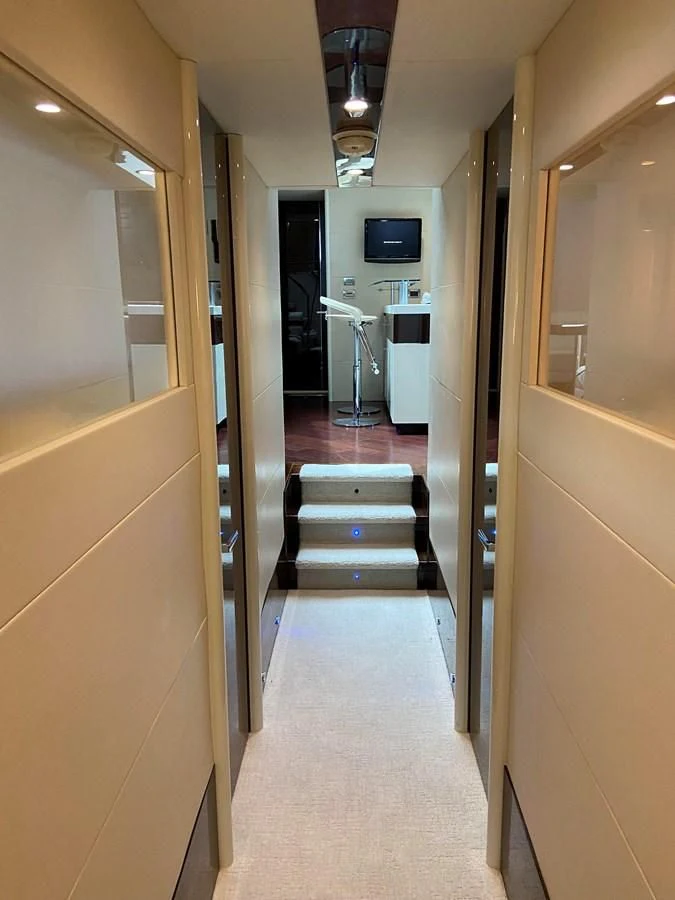 a hallway with a door and a television on the wall aboard BG Yacht for Sale