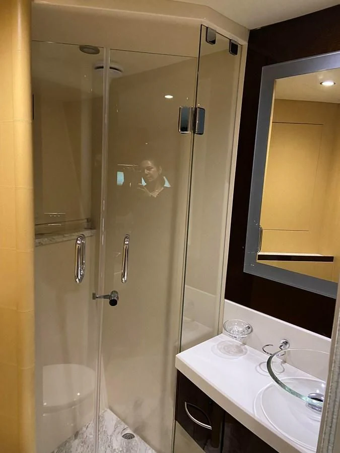 a bathroom with a glass shower aboard BG Yacht for Sale