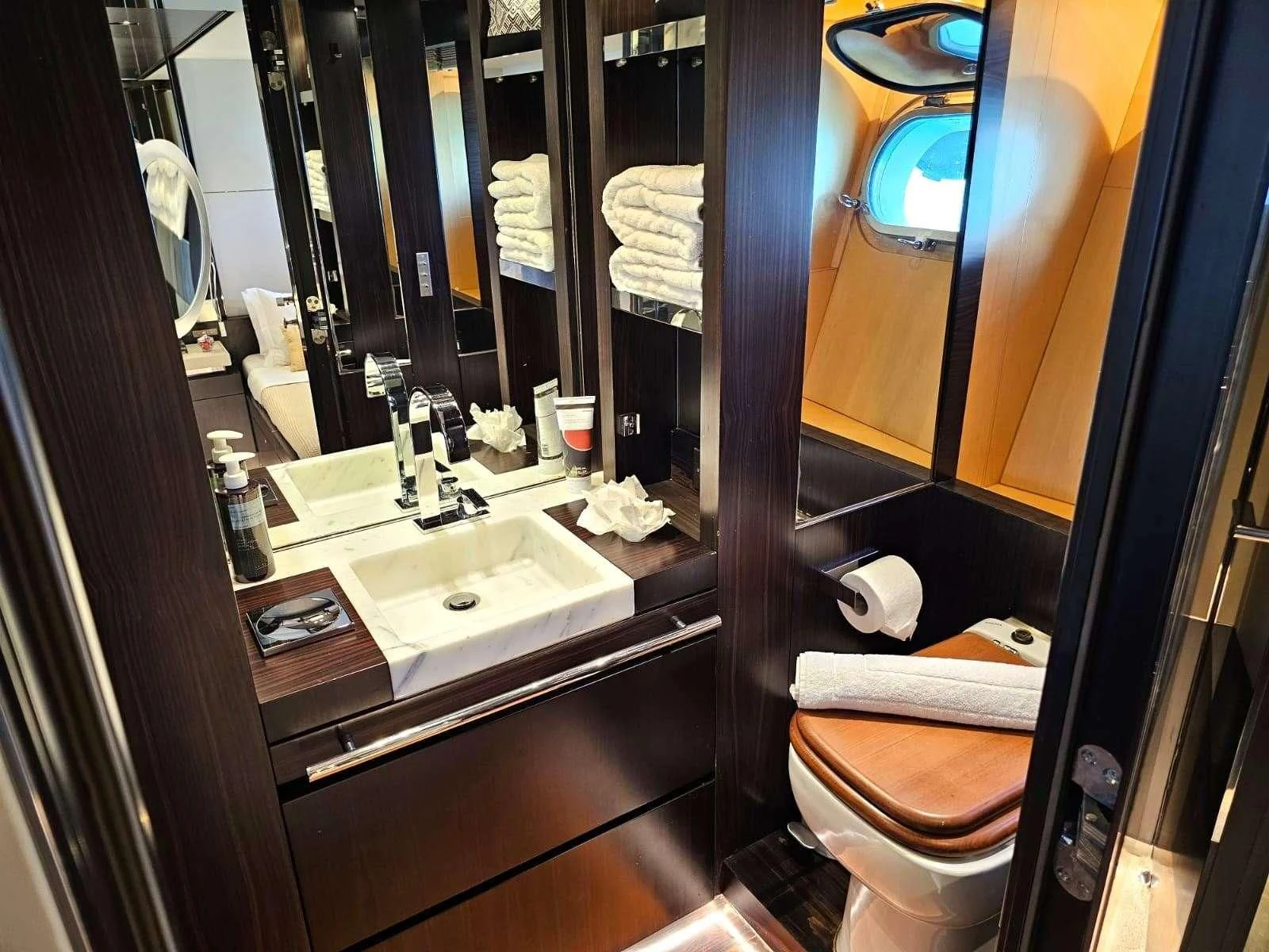 a bathroom with a toilet sink and a mirror aboard MAC Yacht for Sale