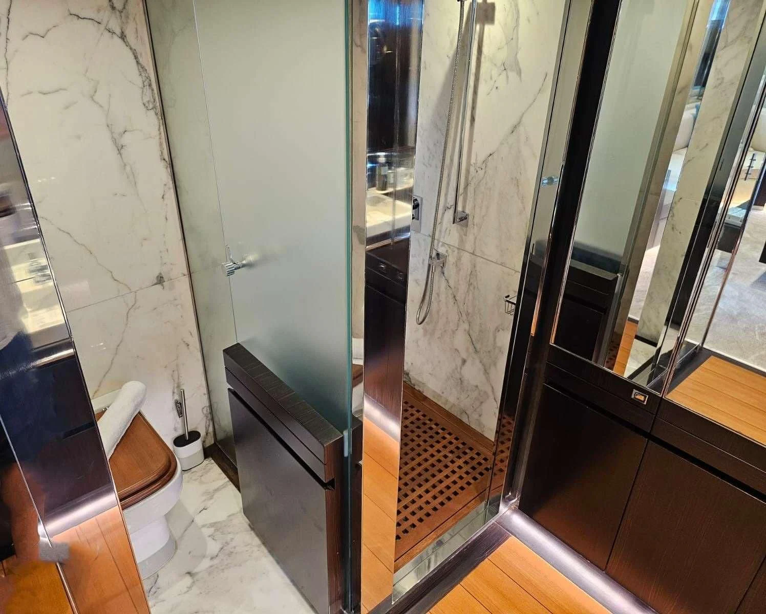 a hallway with glass doors aboard MAC Yacht for Sale