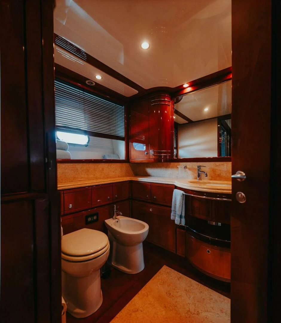 a bathroom with a toilet and a sink aboard LOS ESQUINKLIES Yacht for Sale