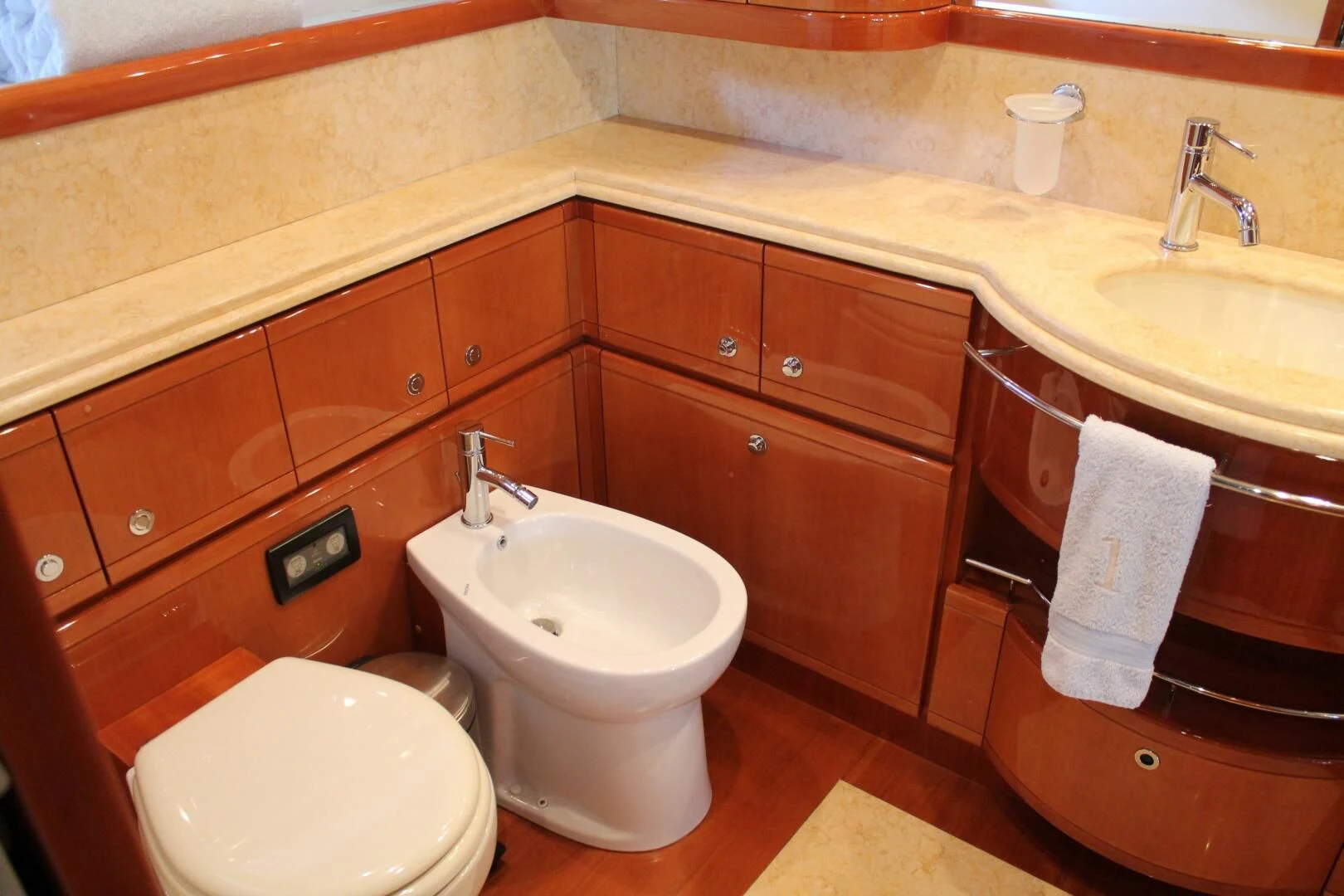 a bathroom with wooden cabinets aboard LOS ESQUINKLIES Yacht for Sale