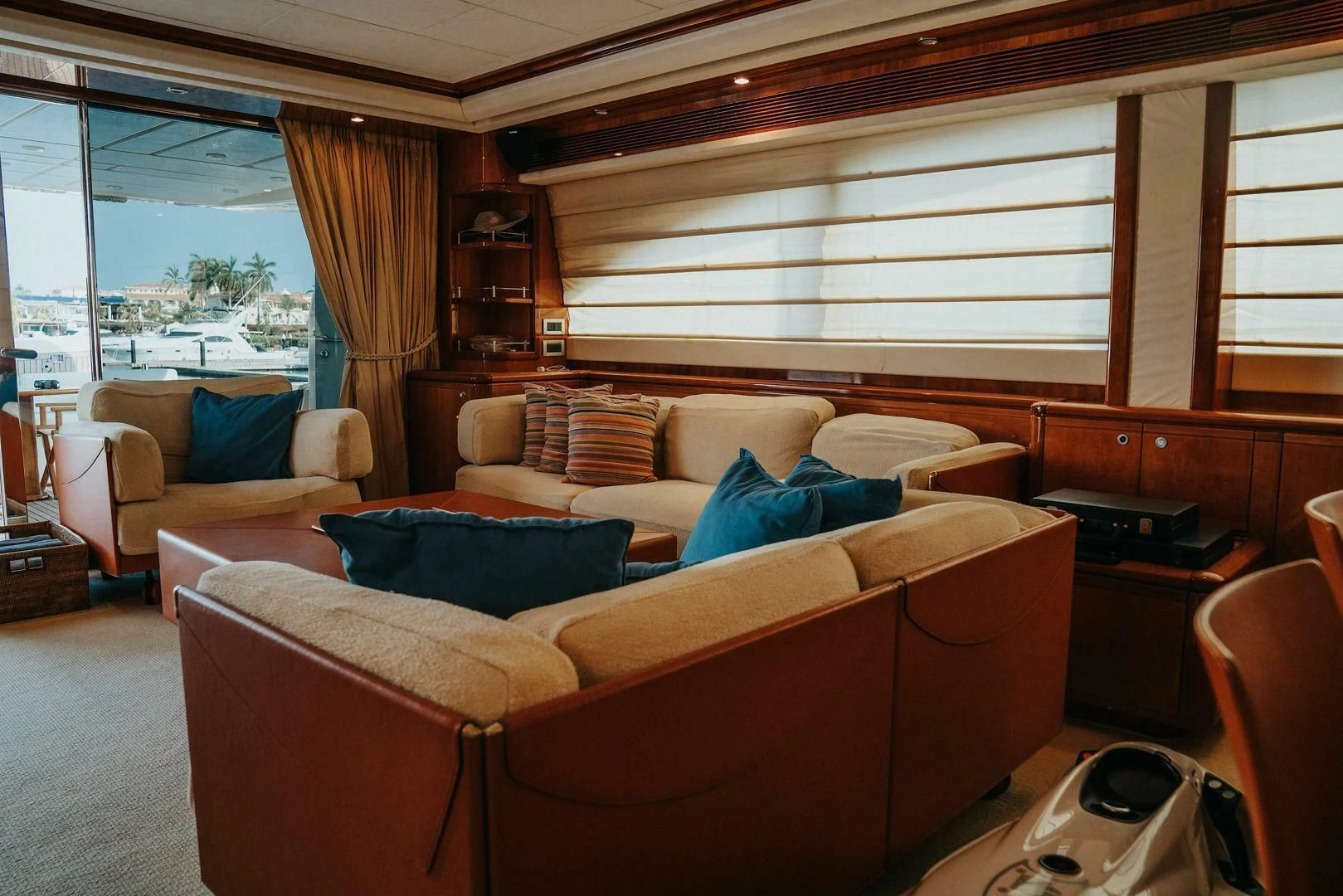 a living room with a couch and a window aboard LOS ESQUINKLIES Yacht for Sale