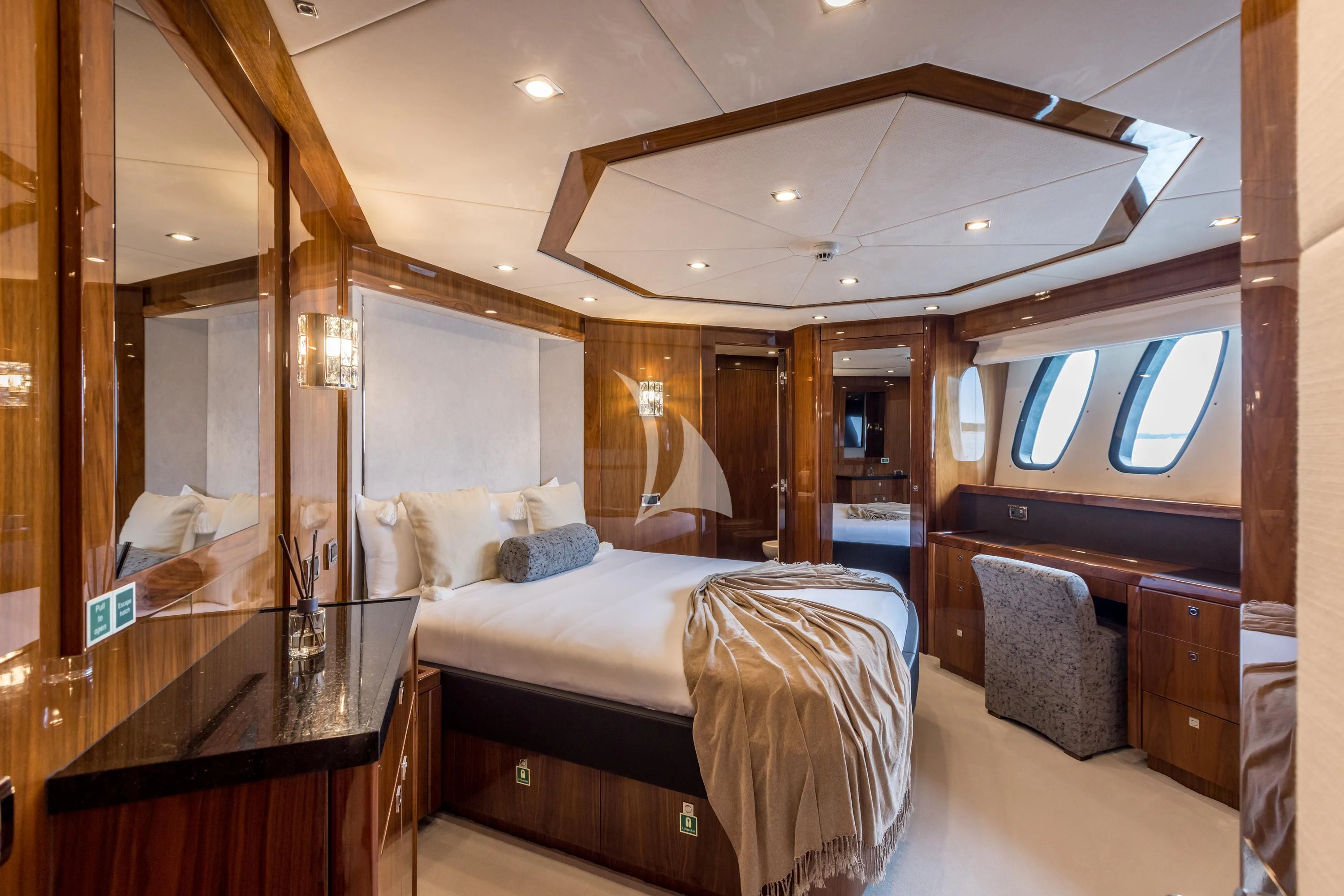 a bedroom with a large mirror aboard KATARIINA I Yacht for Sale