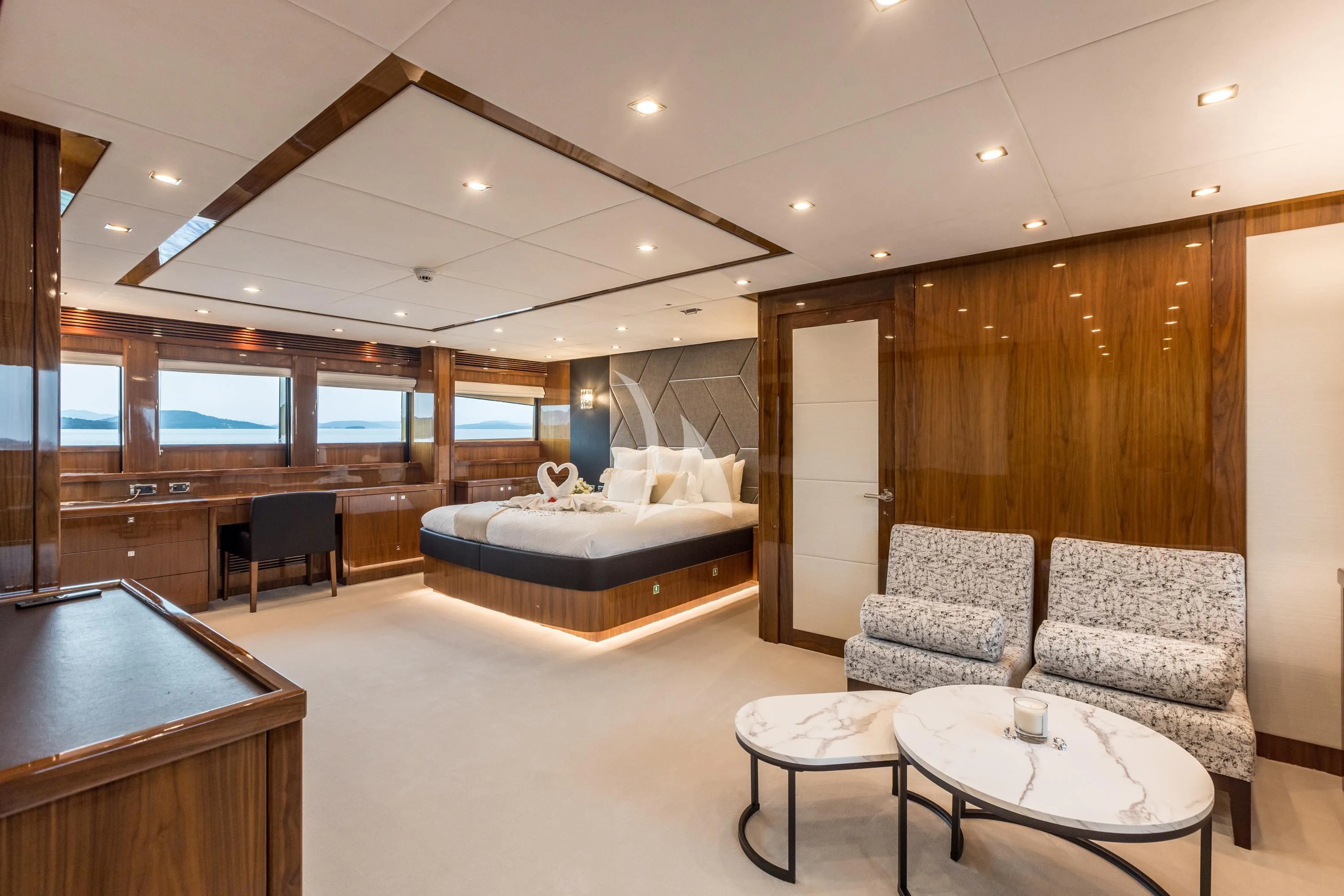a large bedroom with a bed and a desk aboard KATARIINA I Yacht for Sale