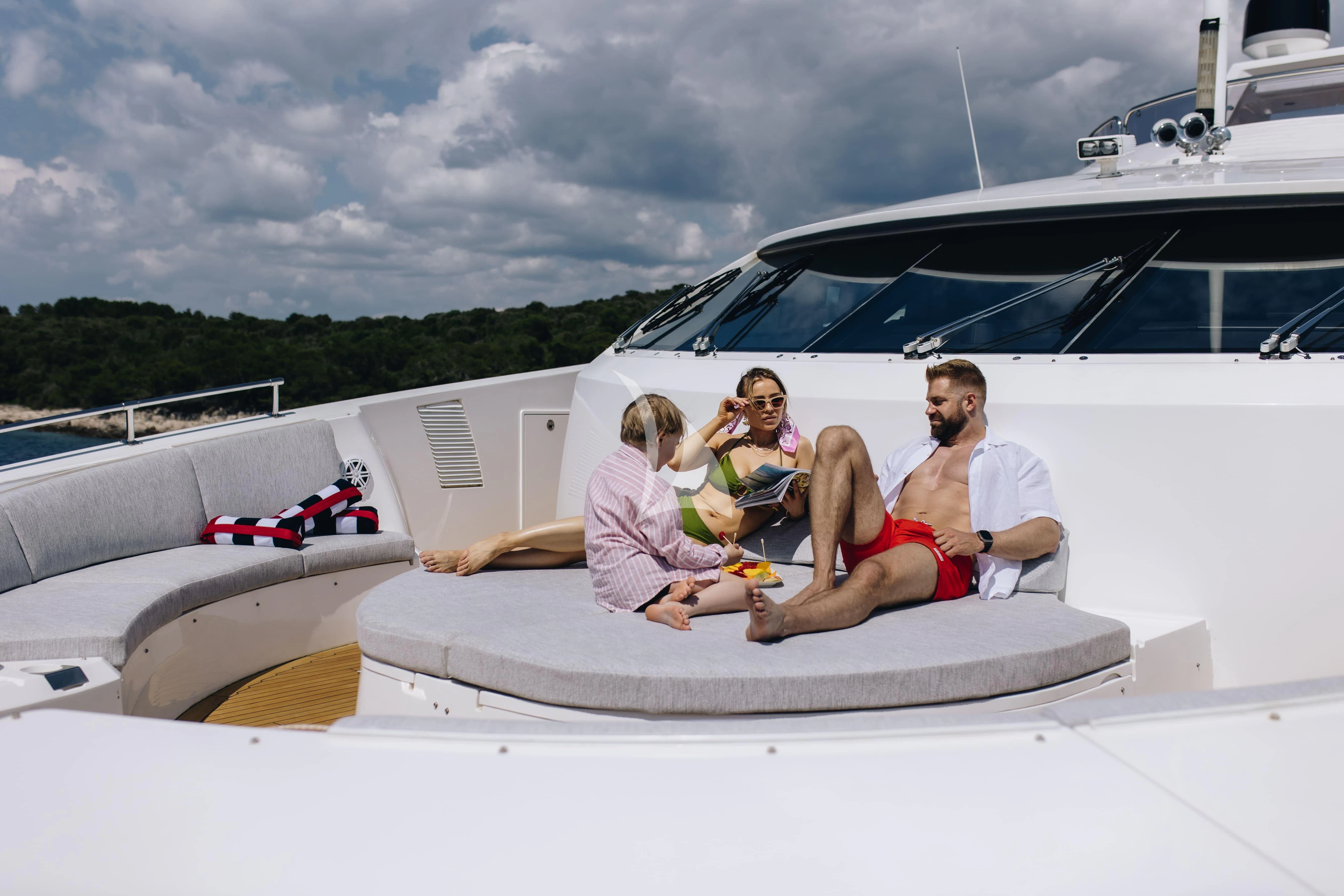 a man and woman sitting on a boat with a child on the front aboard KATARIINA I Yacht for Sale