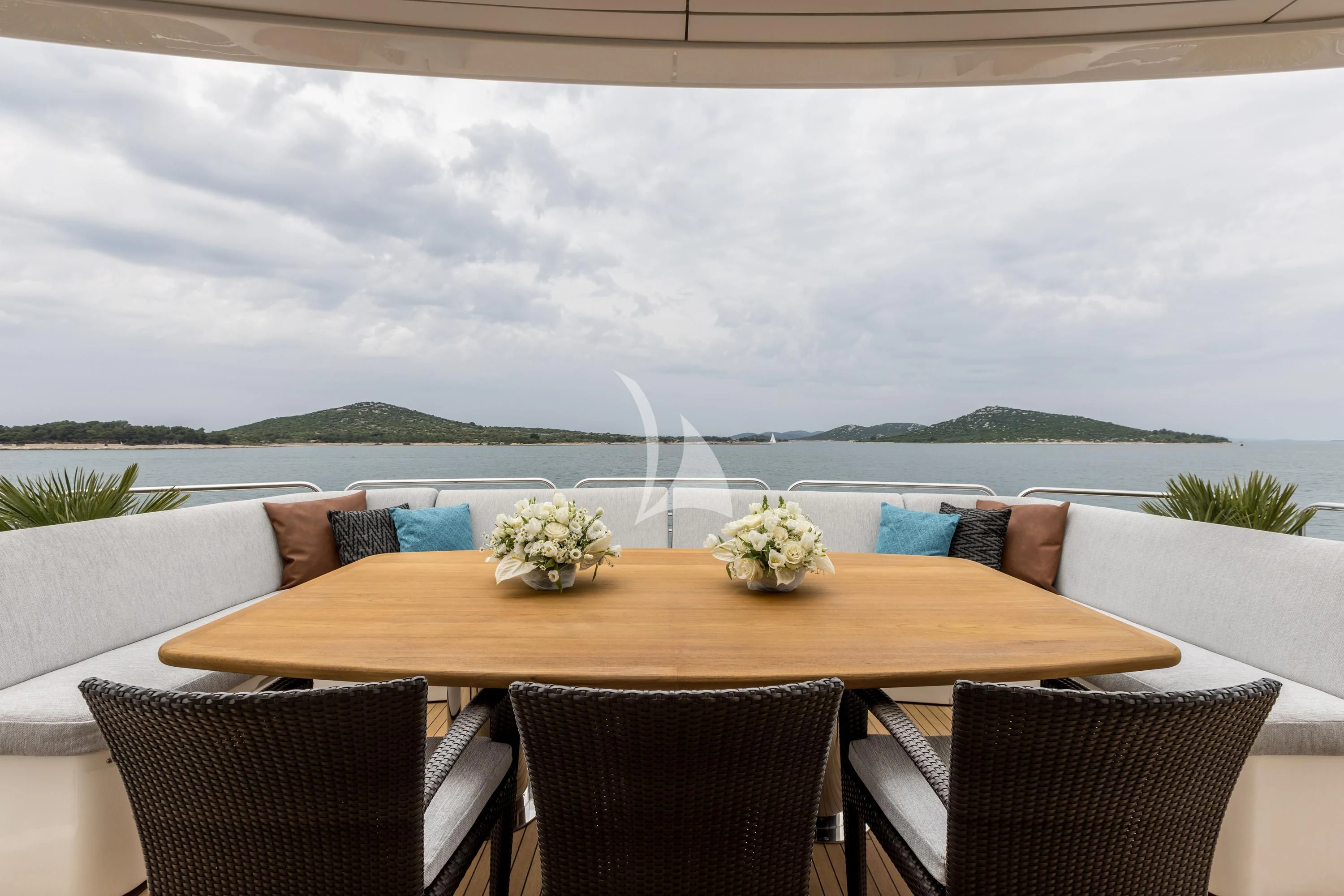 a table with chairs and a fountain aboard KATARIINA I Yacht for Sale