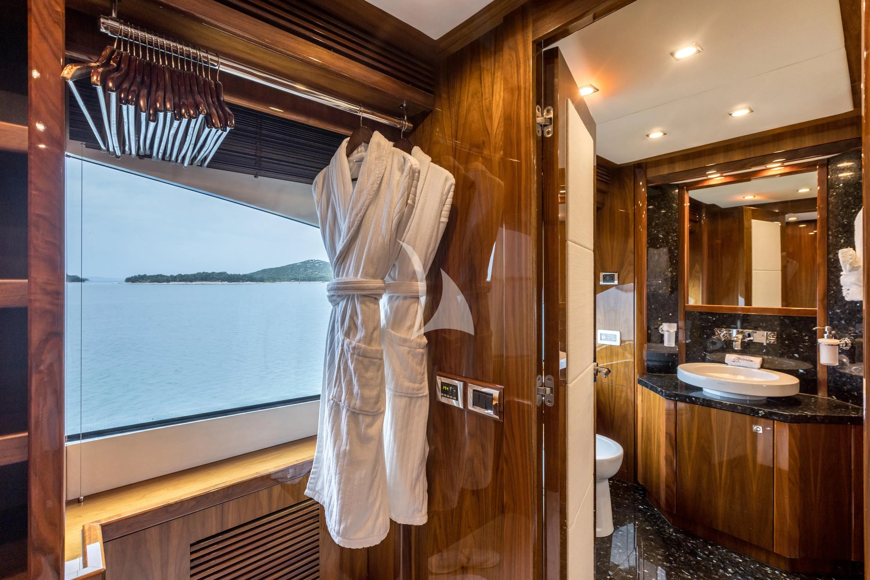 a bathroom with a robe on the wall aboard KATARIINA I Yacht for Sale