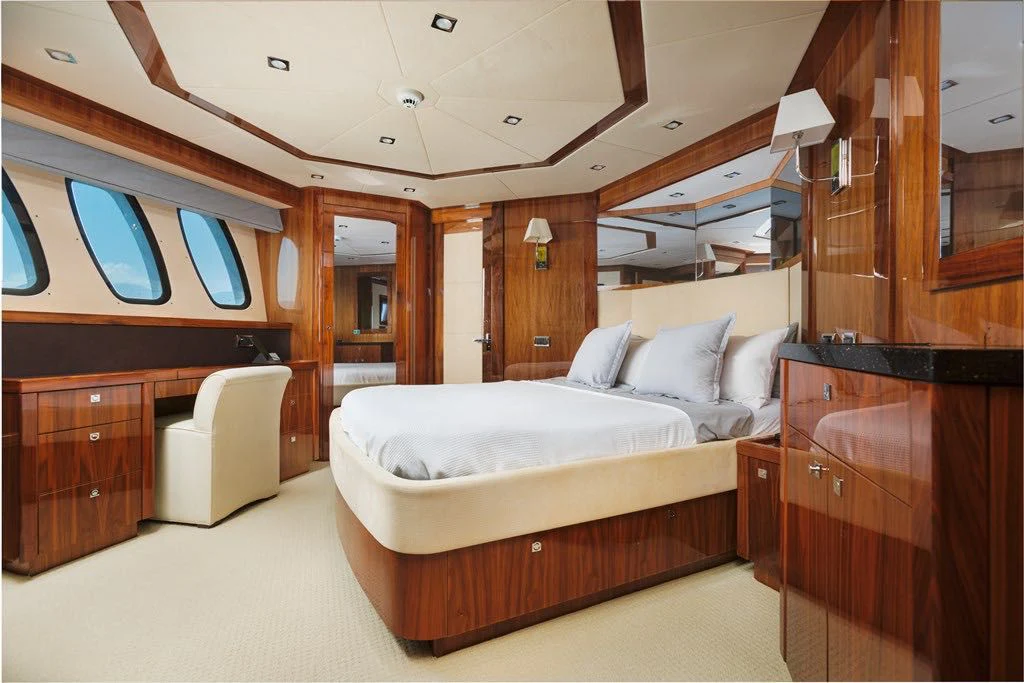 a room with a bed and a chair aboard KATARIINA I Yacht for Sale