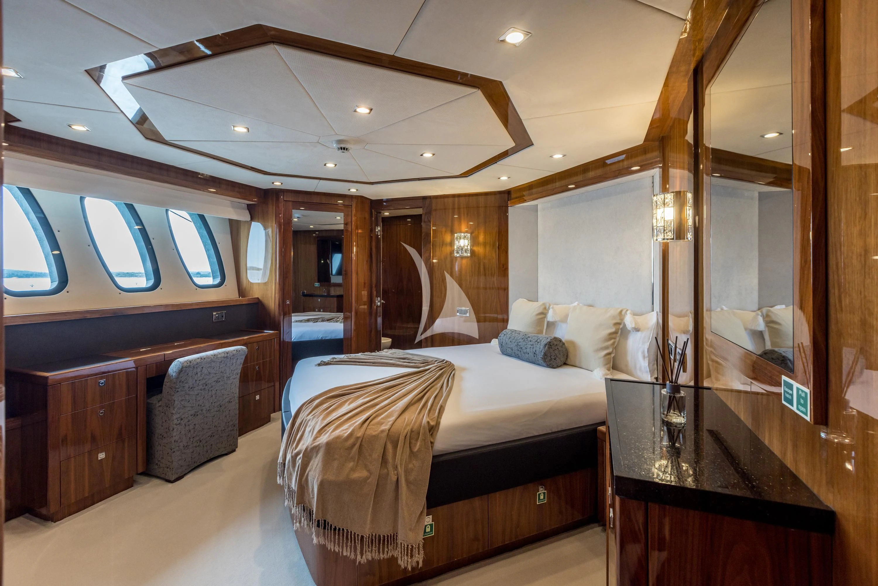 a bedroom with a bed and a desk aboard KATARIINA I Yacht for Sale