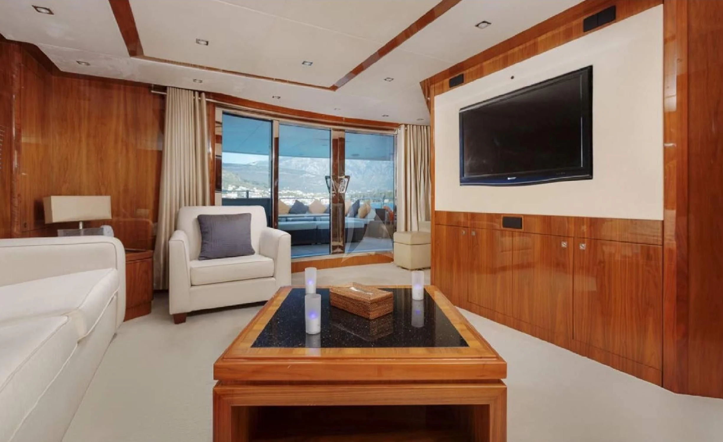 a living room with a tv and a table aboard KATARIINA I Yacht for Sale