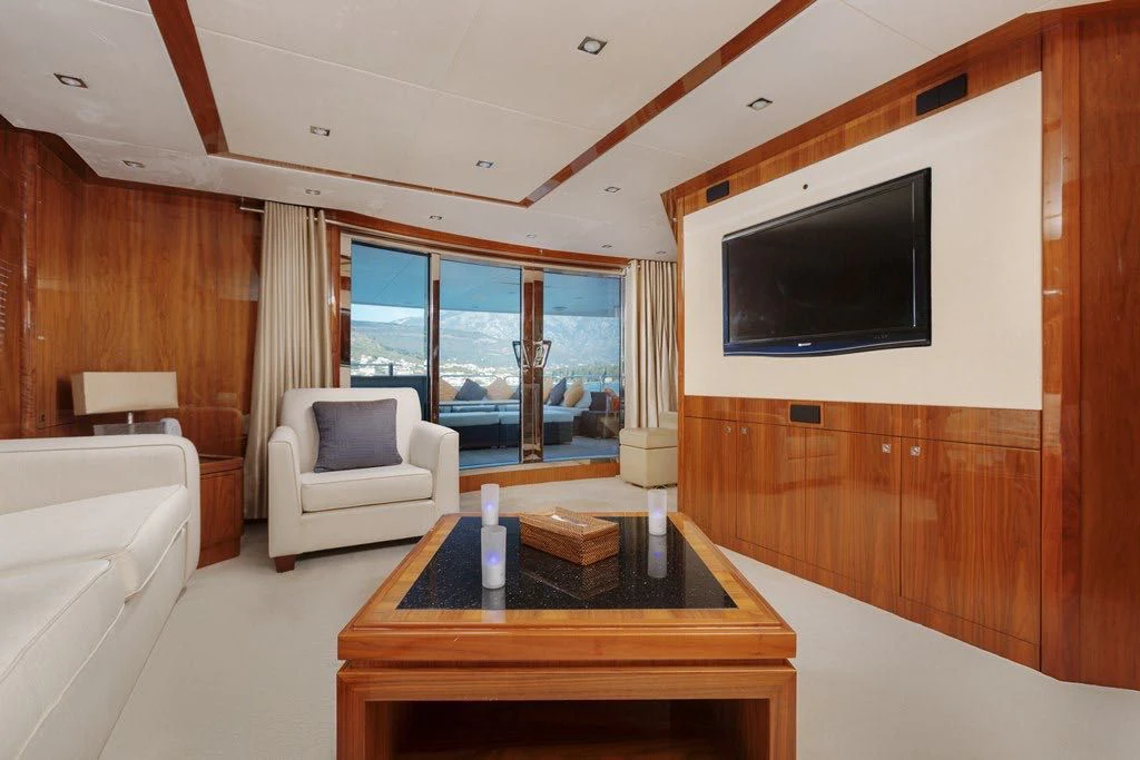 a living room with a tv and a table aboard KATARIINA I Yacht for Sale