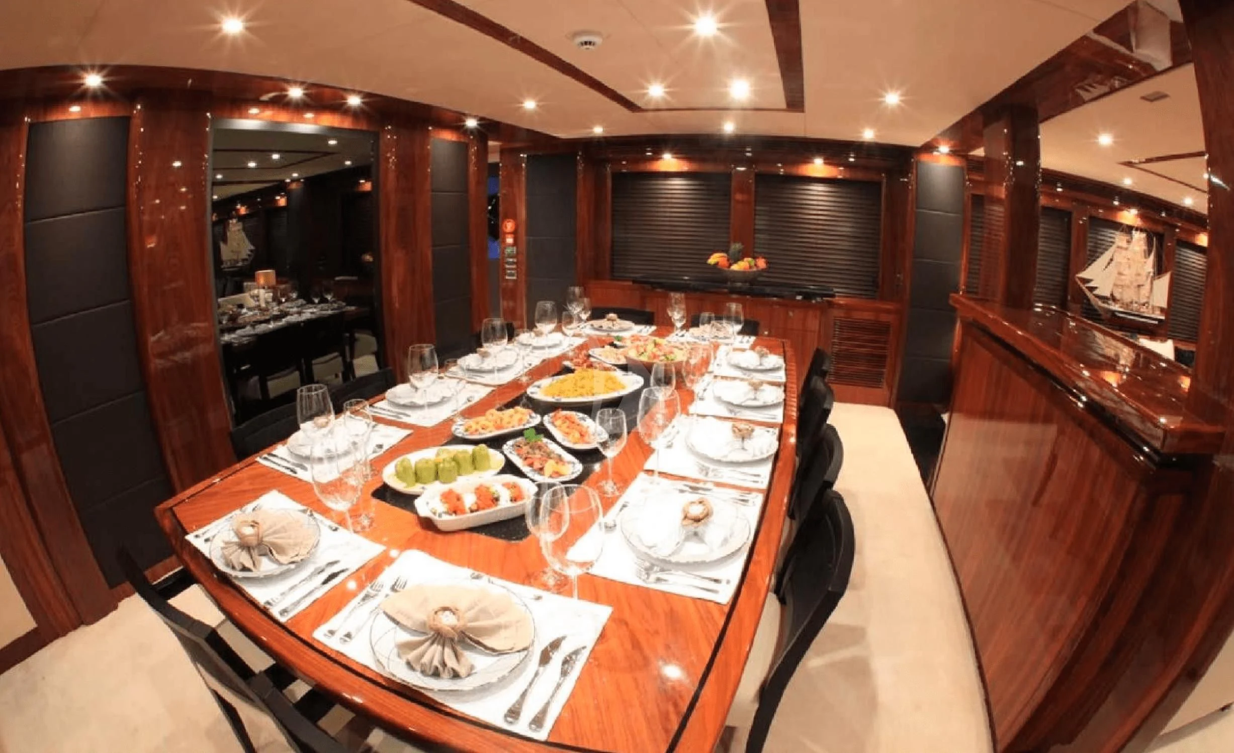 a large dining table with plates and food on it aboard KATARIINA I Yacht for Sale