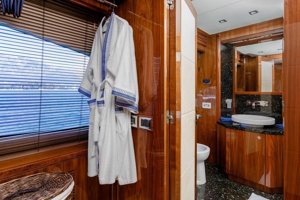 a bathroom with a robe on the wall aboard KATARIINA I Yacht for Sale