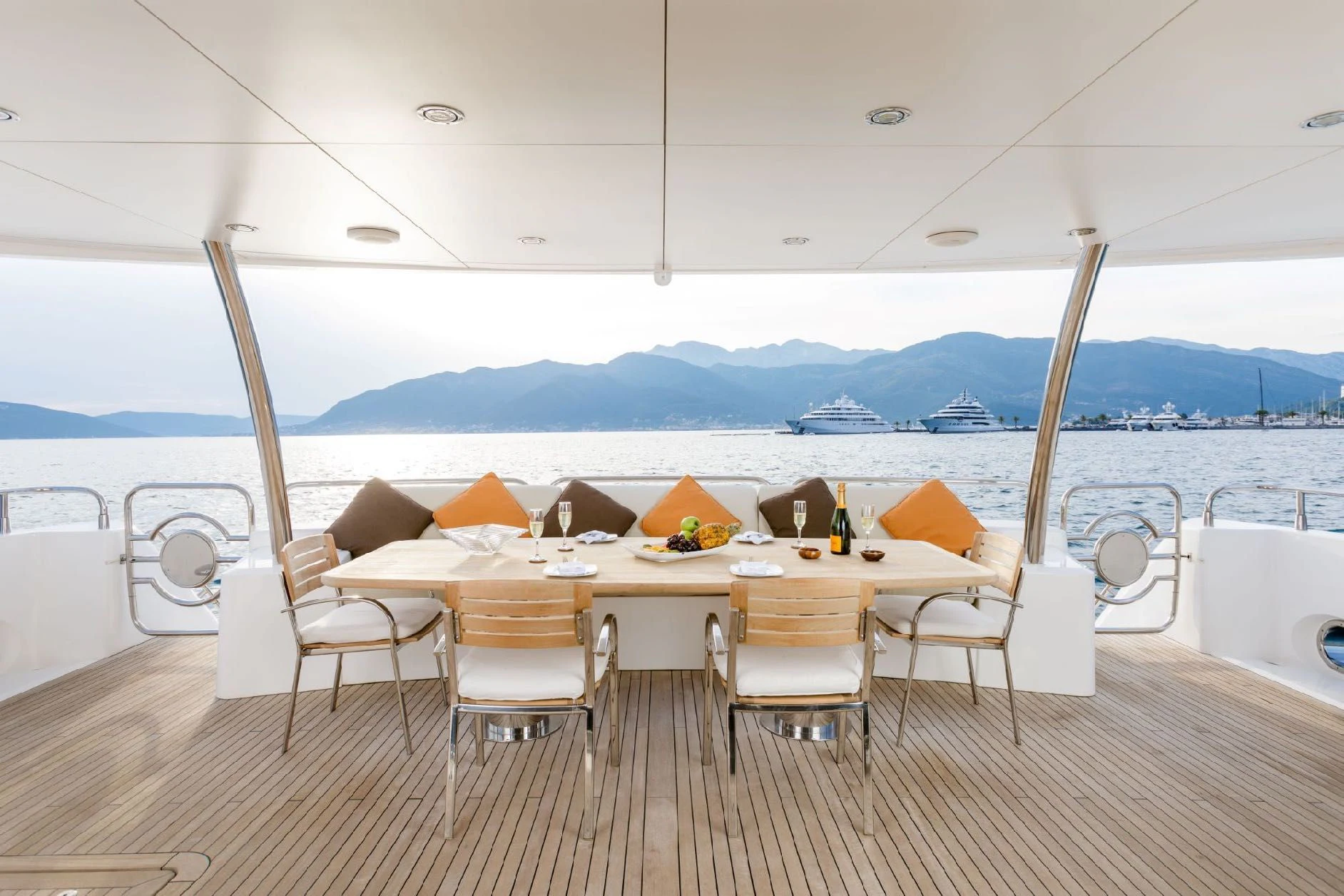 a table set for a meal on a deck overlooking the ocean aboard KATARIINA I Yacht for Sale