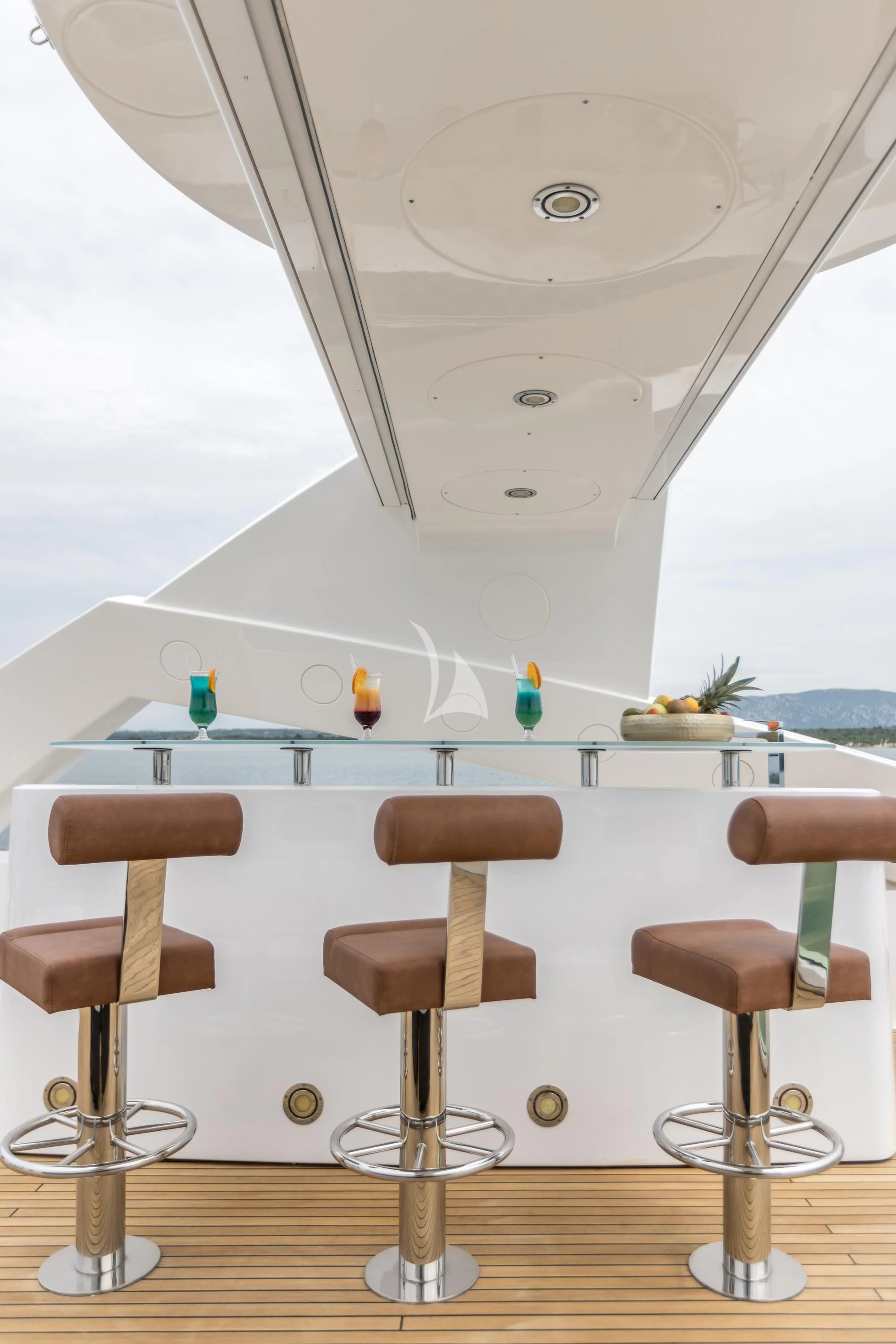 a room with stools and a table aboard KATARIINA I Yacht for Sale