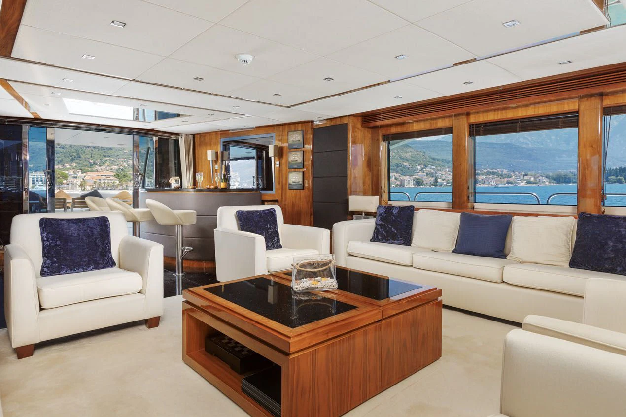 a living room with a table and couches aboard KATARIINA I Yacht for Sale