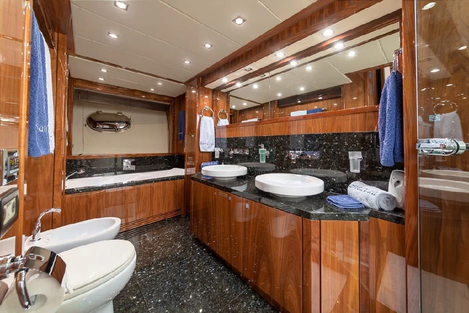 a bathroom with a countertop sink and a large mirror aboard KATARIINA I Yacht for Sale