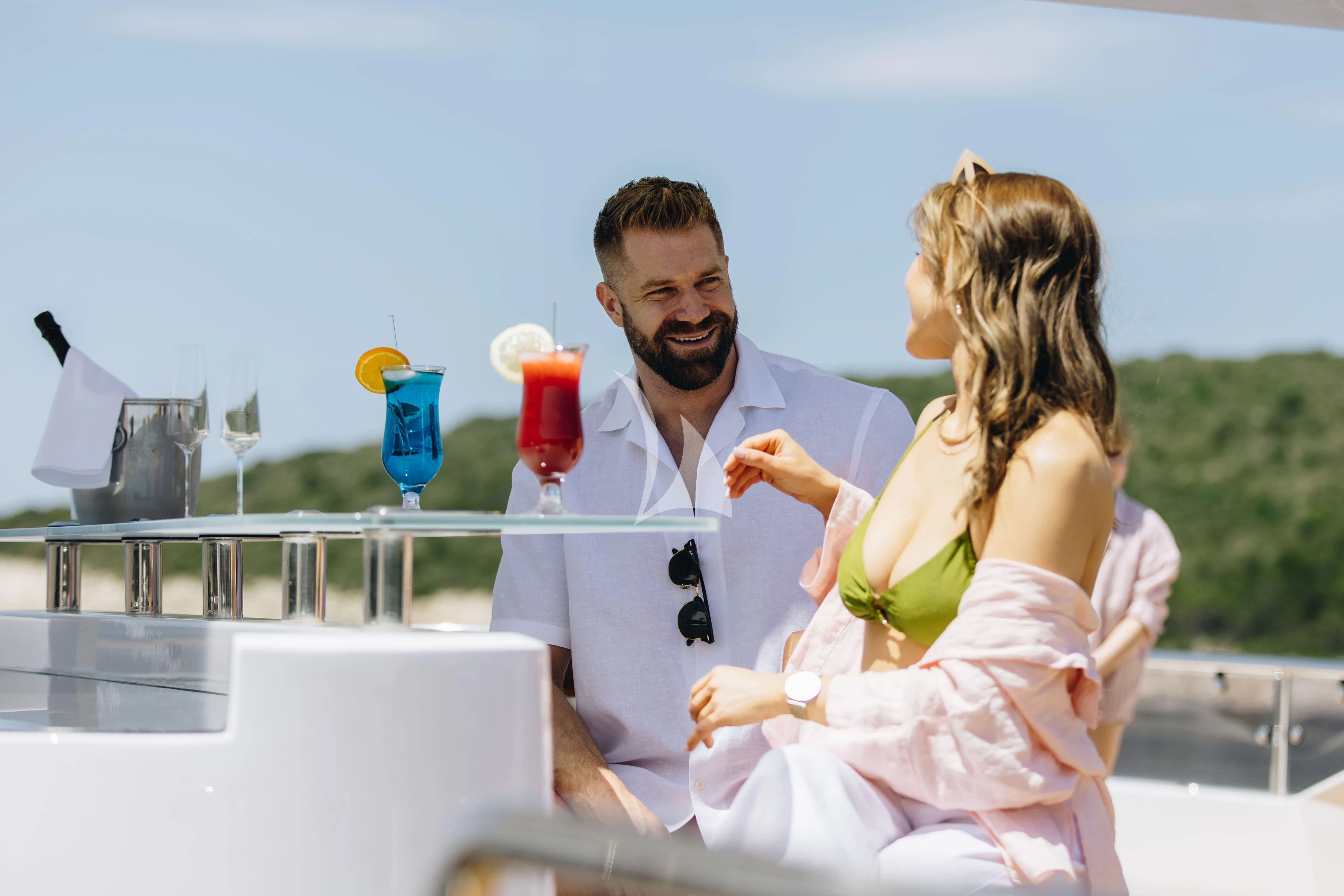 a man and woman in white aboard KATARIINA I Yacht for Sale