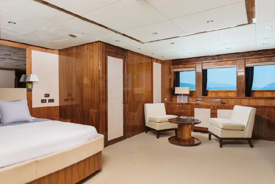 a room with a bed and a desk aboard KATARIINA I Yacht for Sale