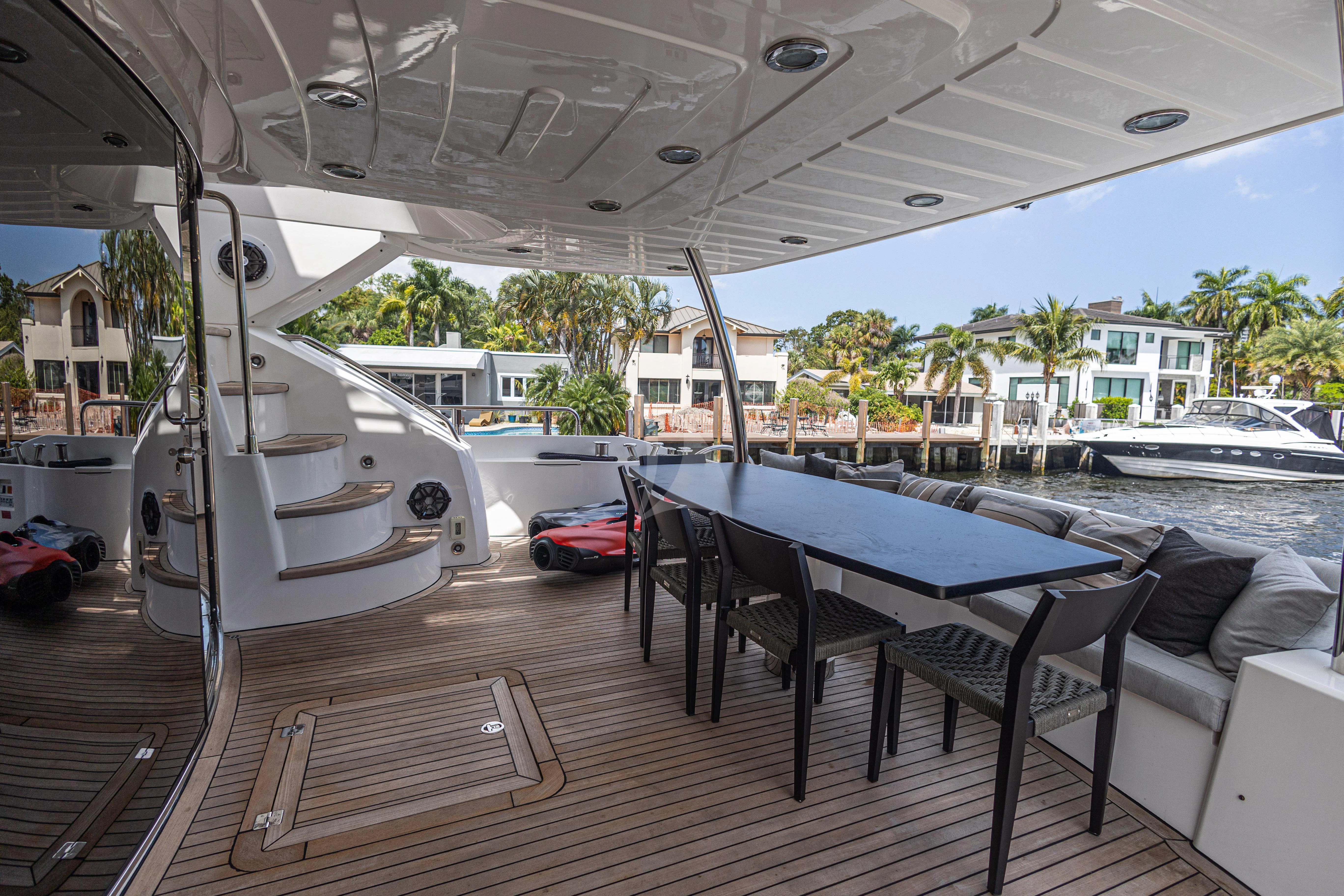 a deck with a table and chairs aboard MOZZ II Yacht for Sale