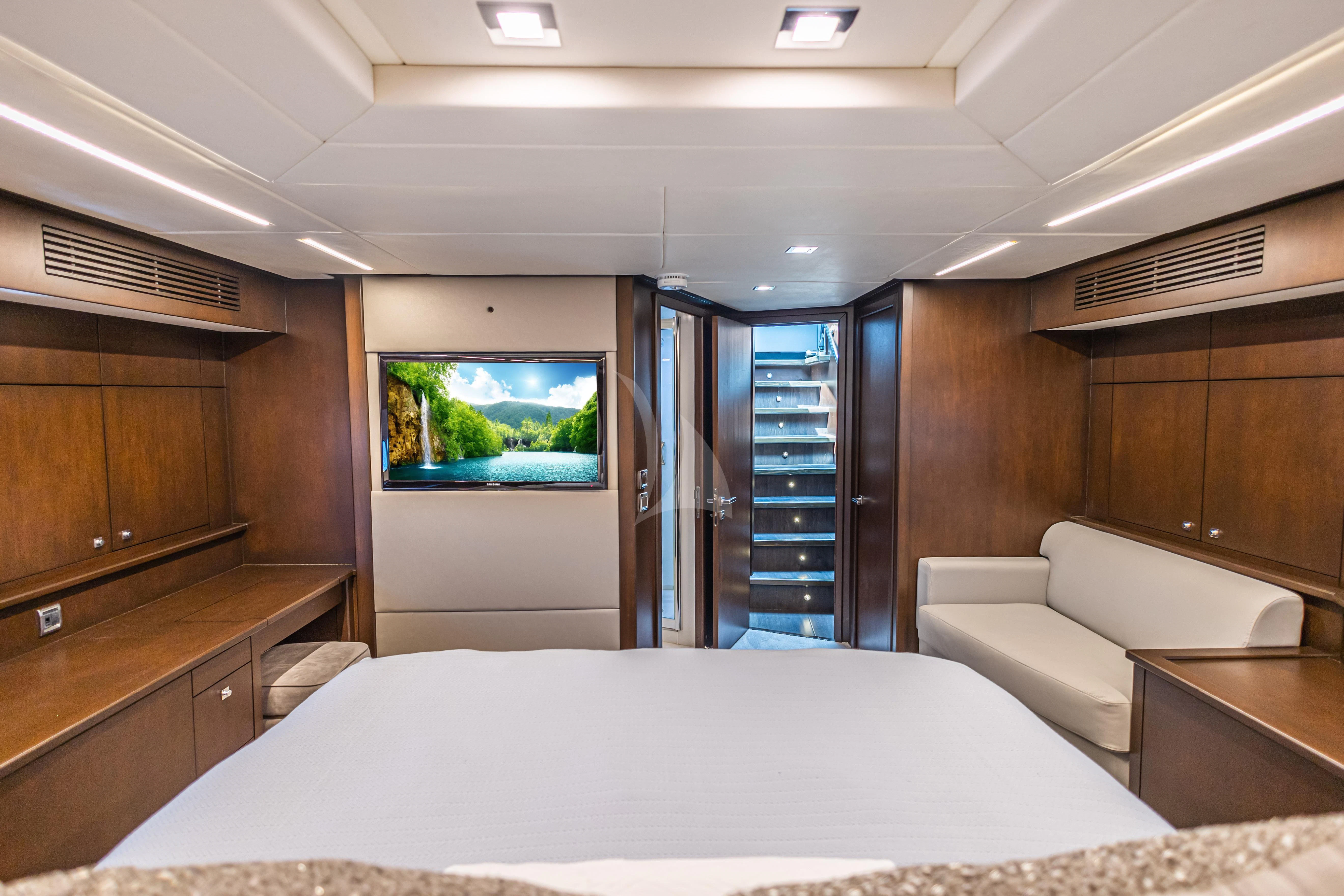 a bedroom with a bed and a television aboard MOZZ II Yacht for Sale
