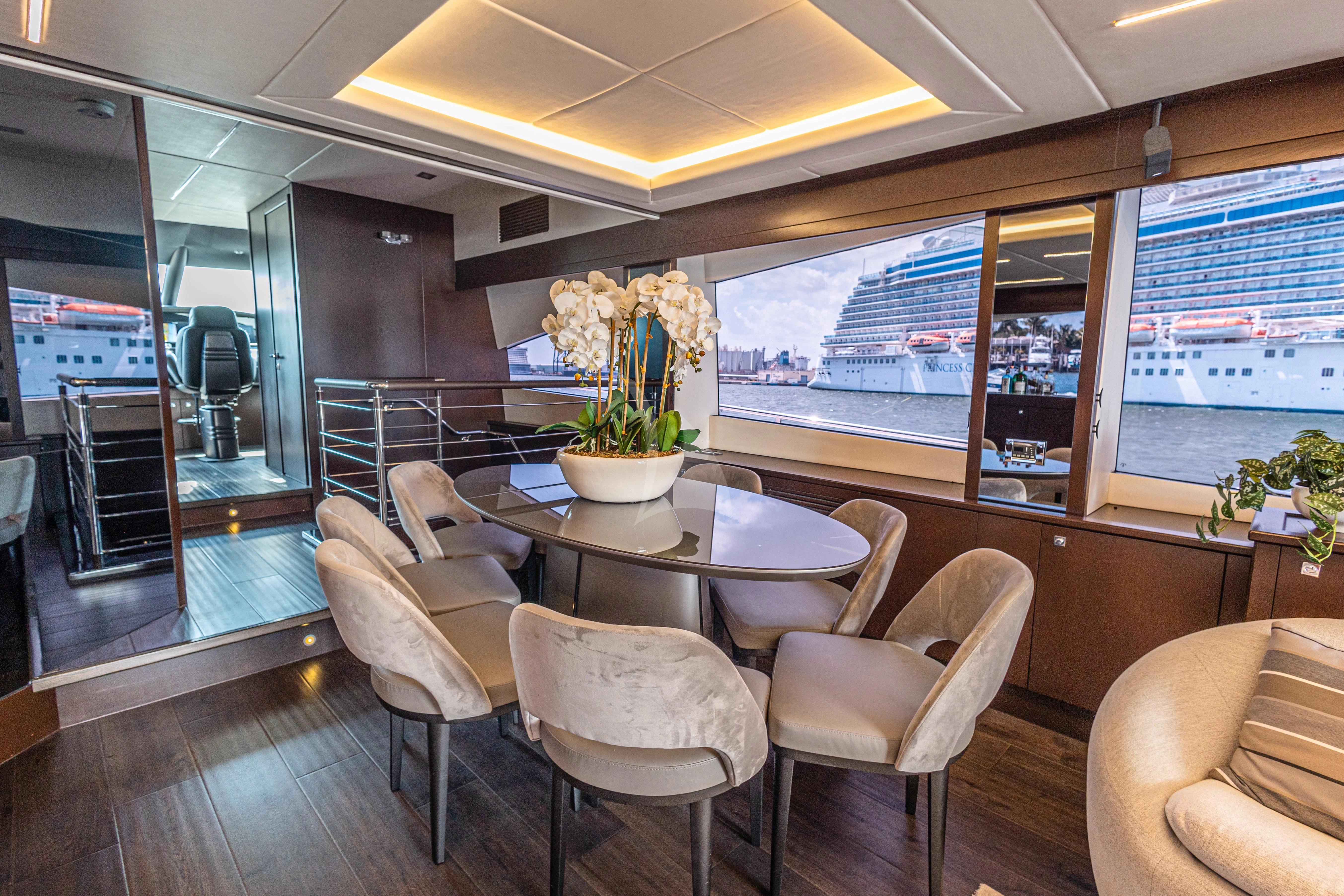 a room with a table chairs and a large window aboard MOZZ II Yacht for Sale