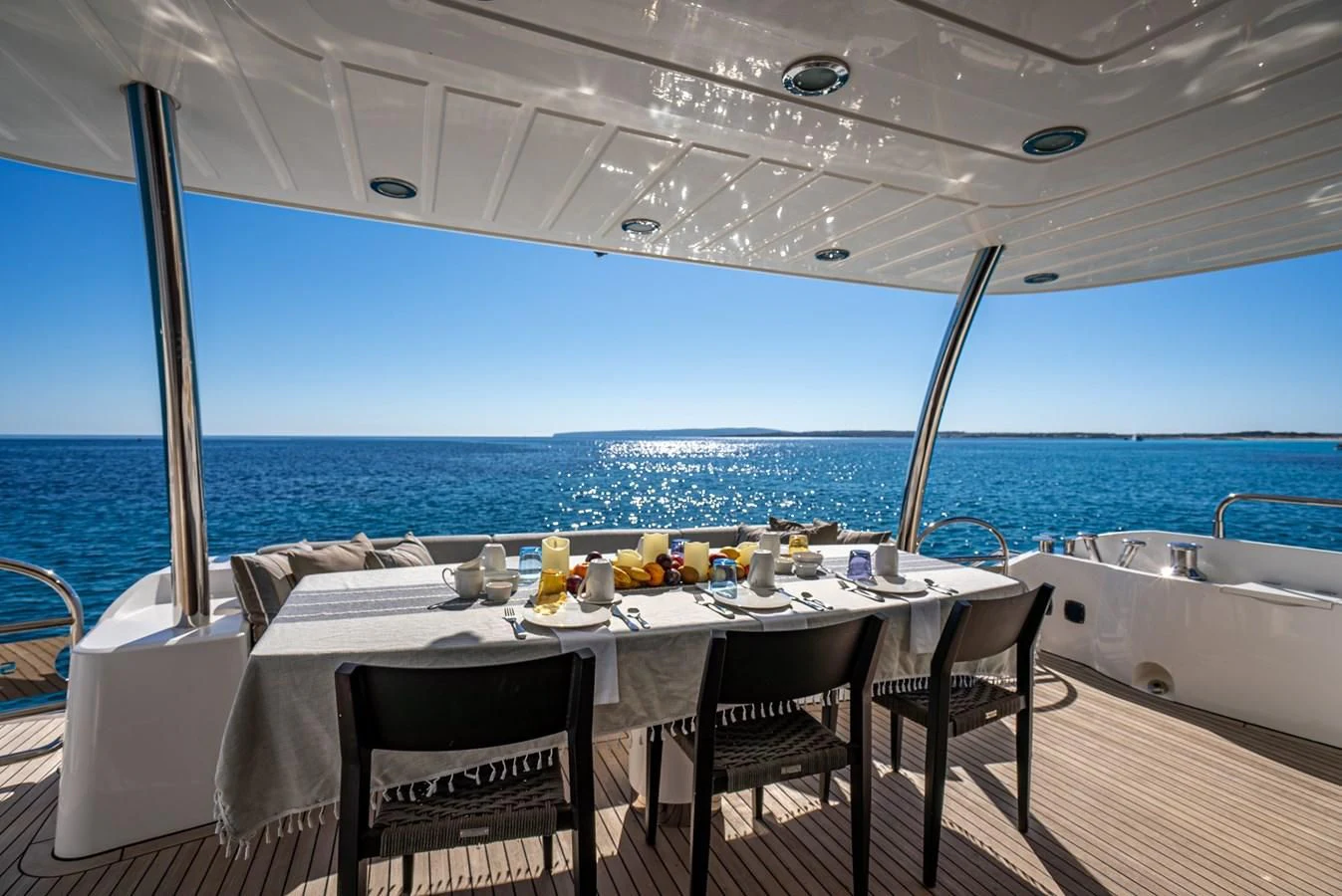a table set for a meal on a boat aboard MOZZ II Yacht for Sale