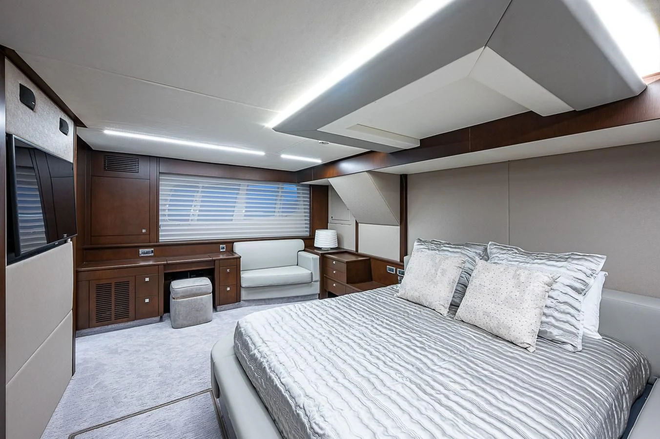 a bedroom with a bed and a desk aboard MOZZ II Yacht for Sale