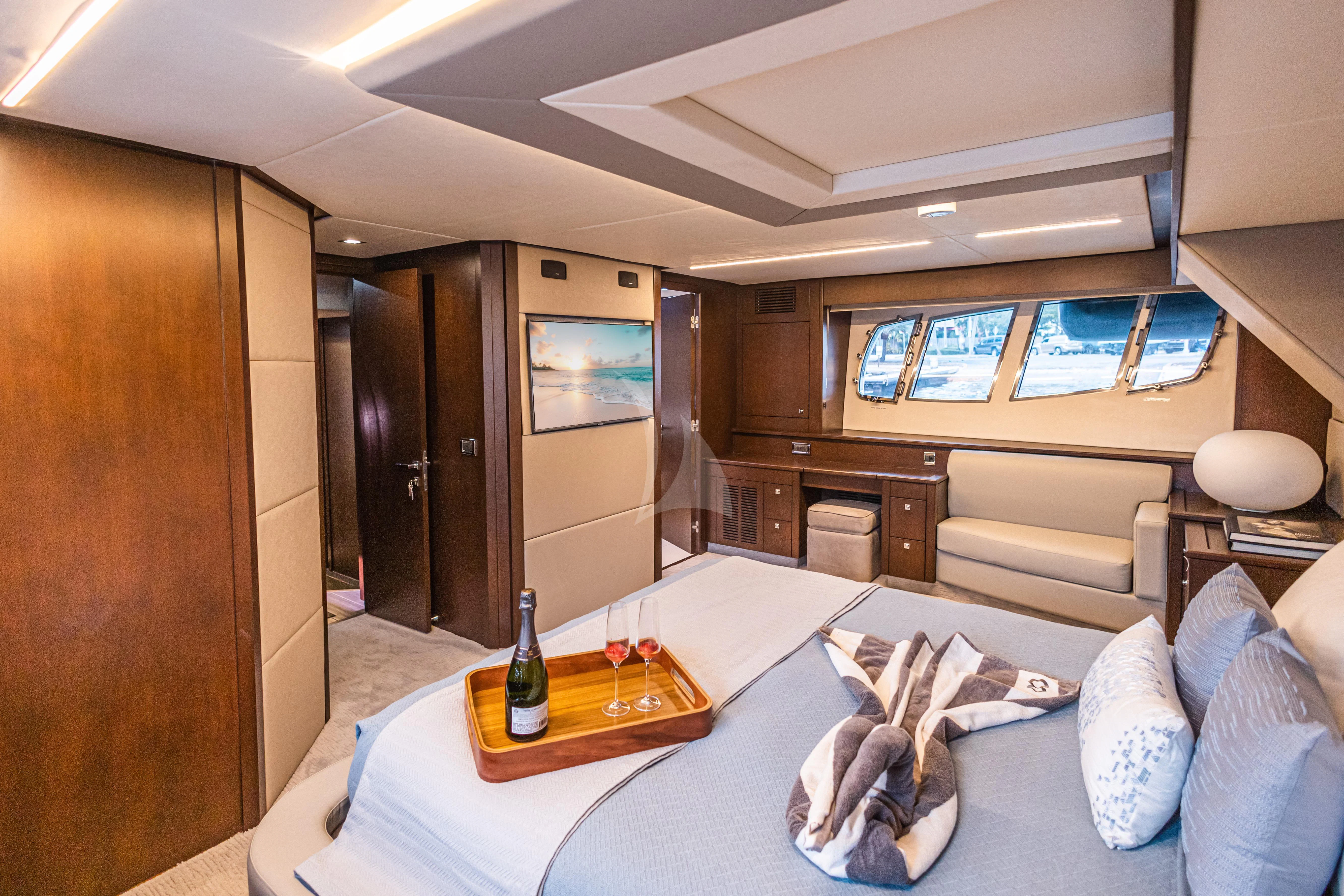 a room with a couch and a table with a glass of wine aboard MOZZ II Yacht for Sale