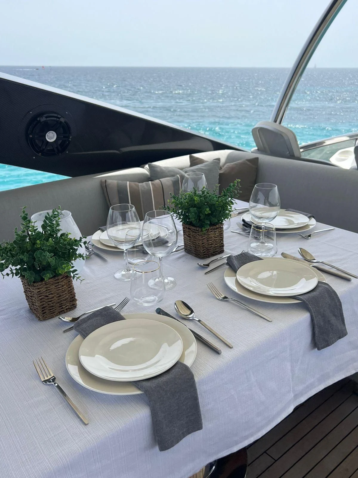 a table with plates and silverware aboard MOZZ II Yacht for Sale