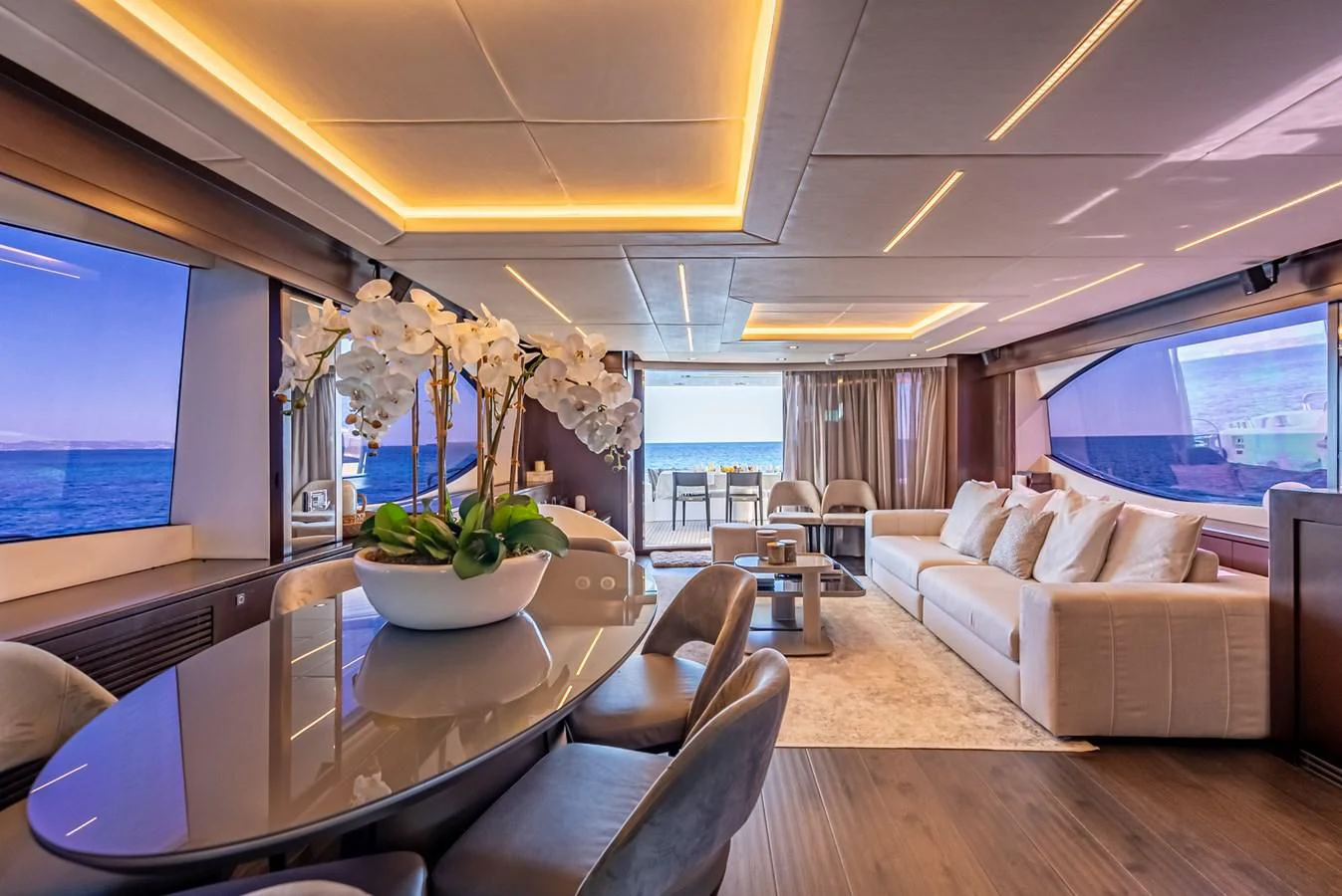 a living room with a large table and a large window aboard MOZZ II Yacht for Sale