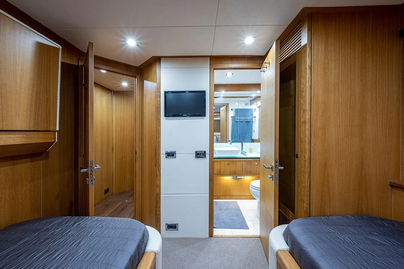 a bedroom with a bed and a television aboard MOZZ II Yacht for Sale