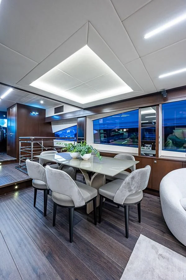 a room with a table and chairs aboard MOZZ II Yacht for Sale