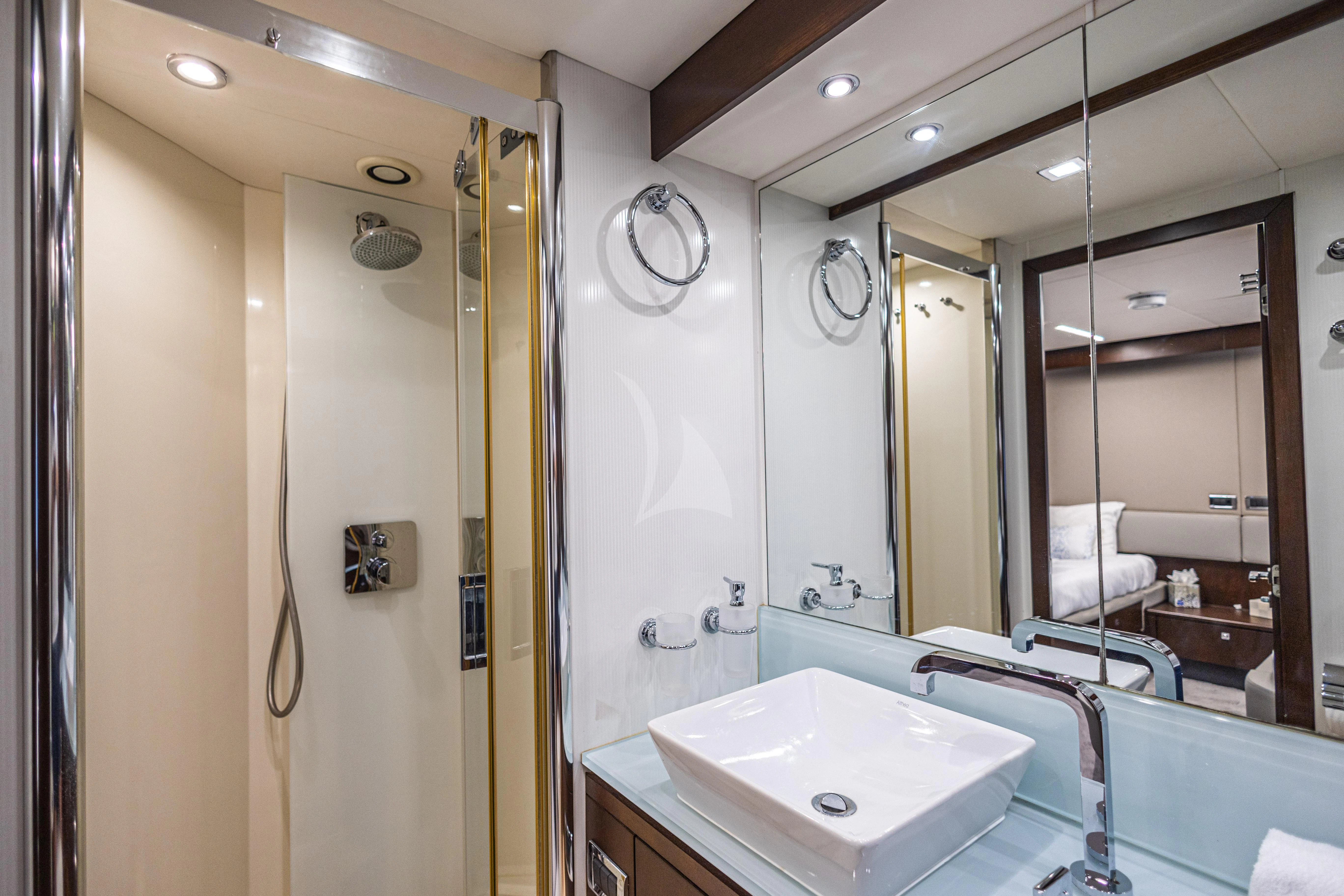a bathroom with a sink and a mirror aboard MOZZ II Yacht for Sale