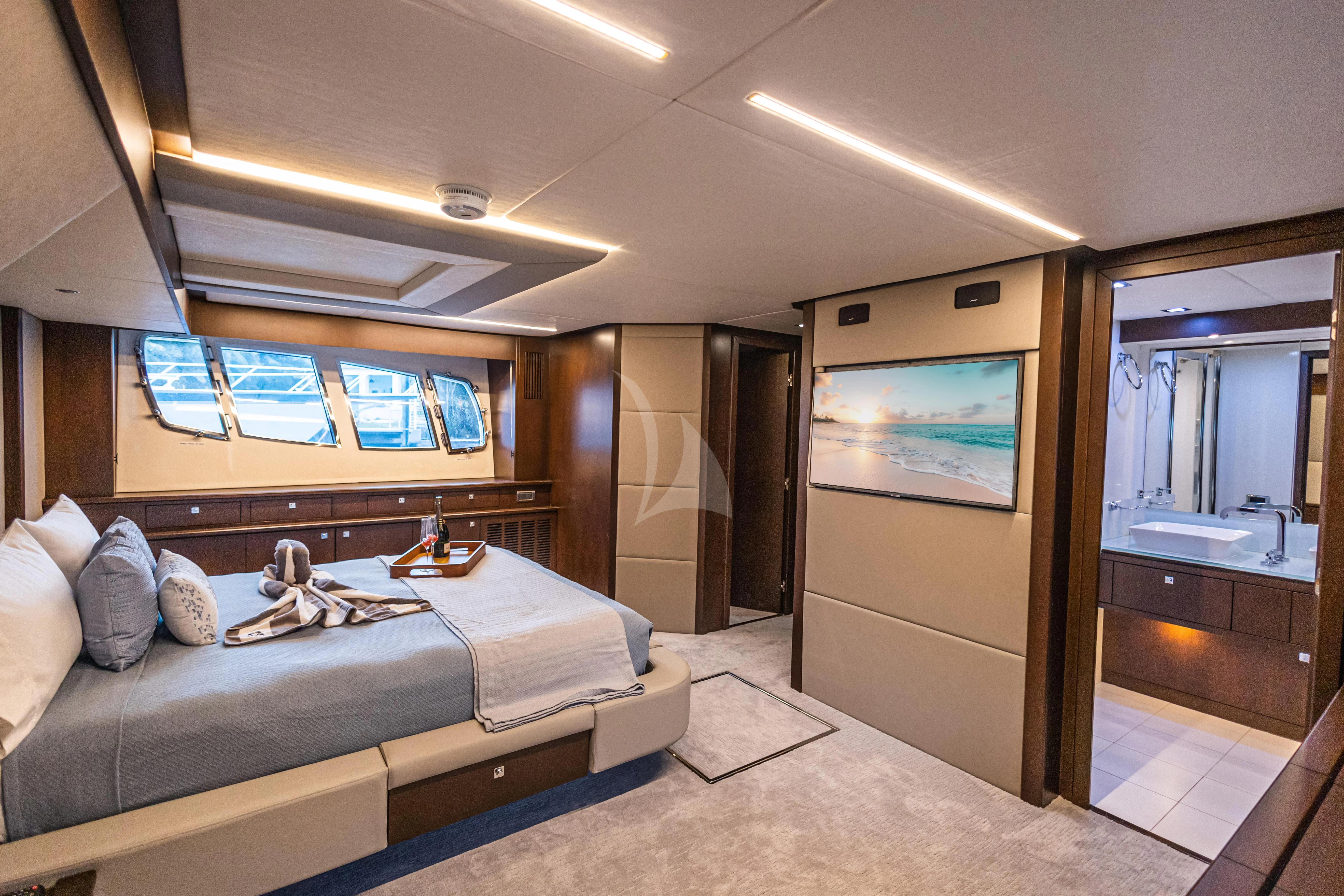 a bedroom with a bed and a mirror aboard MOZZ II Yacht for Sale
