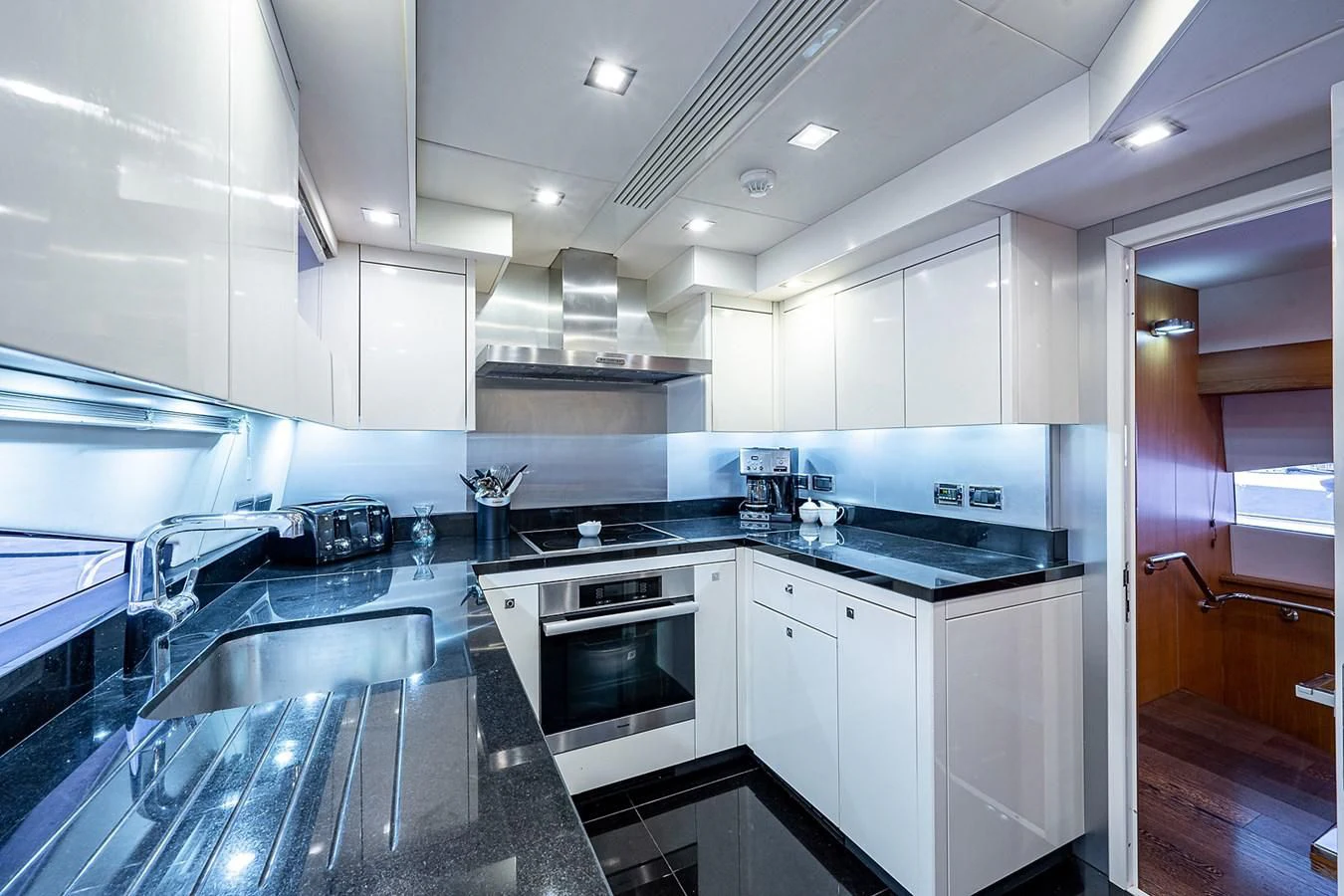 a kitchen with white cabinets aboard MOZZ II Yacht for Sale