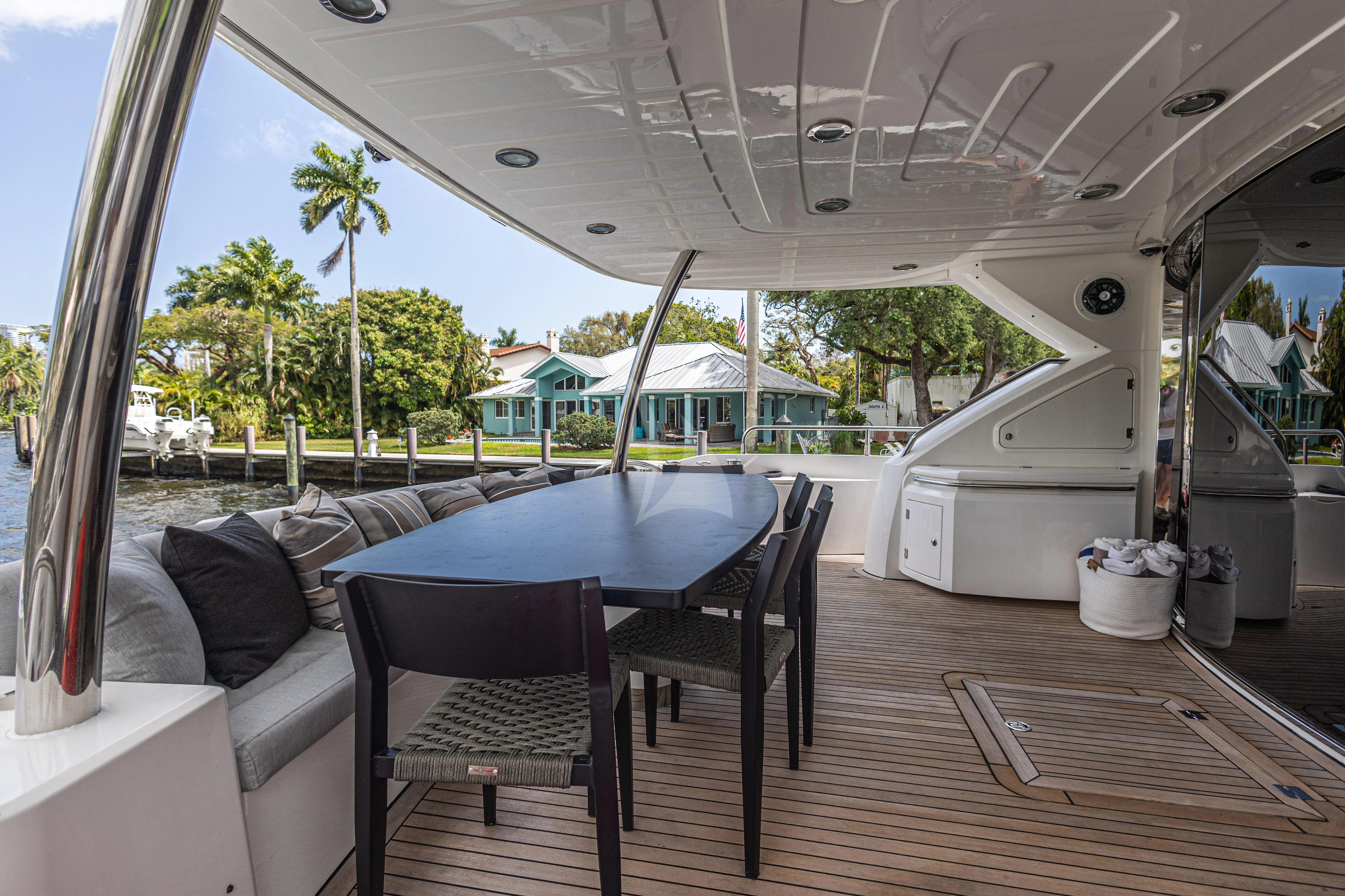 a deck with a table and chairs aboard MOZZ II Yacht for Sale