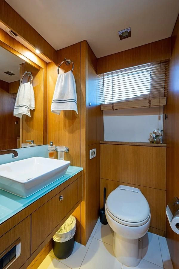 a bathroom with a sink toilet and a mirror aboard MOZZ II Yacht for Sale