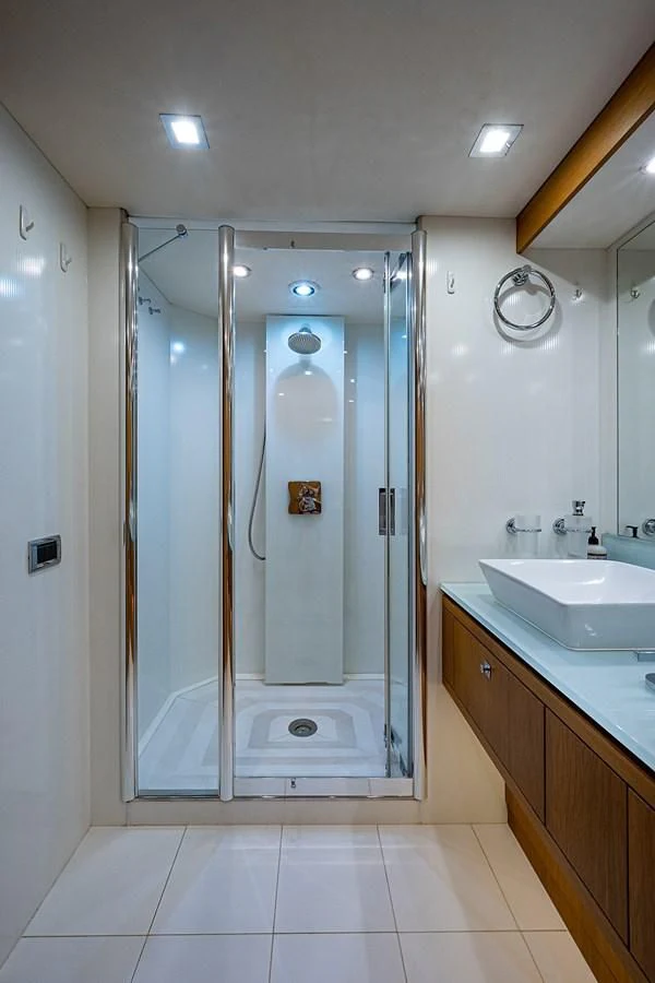 a bathroom with a glass shower aboard MOZZ II Yacht for Sale