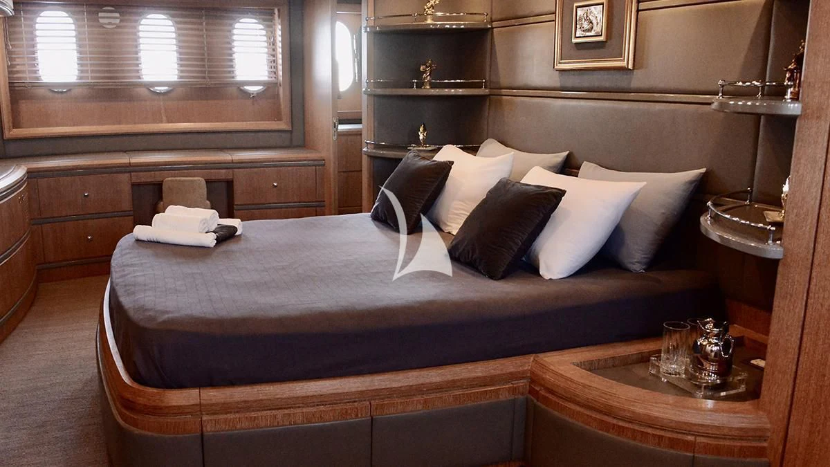 a bed with a black and white bed spread aboard OBSIDIAN Yacht for Sale