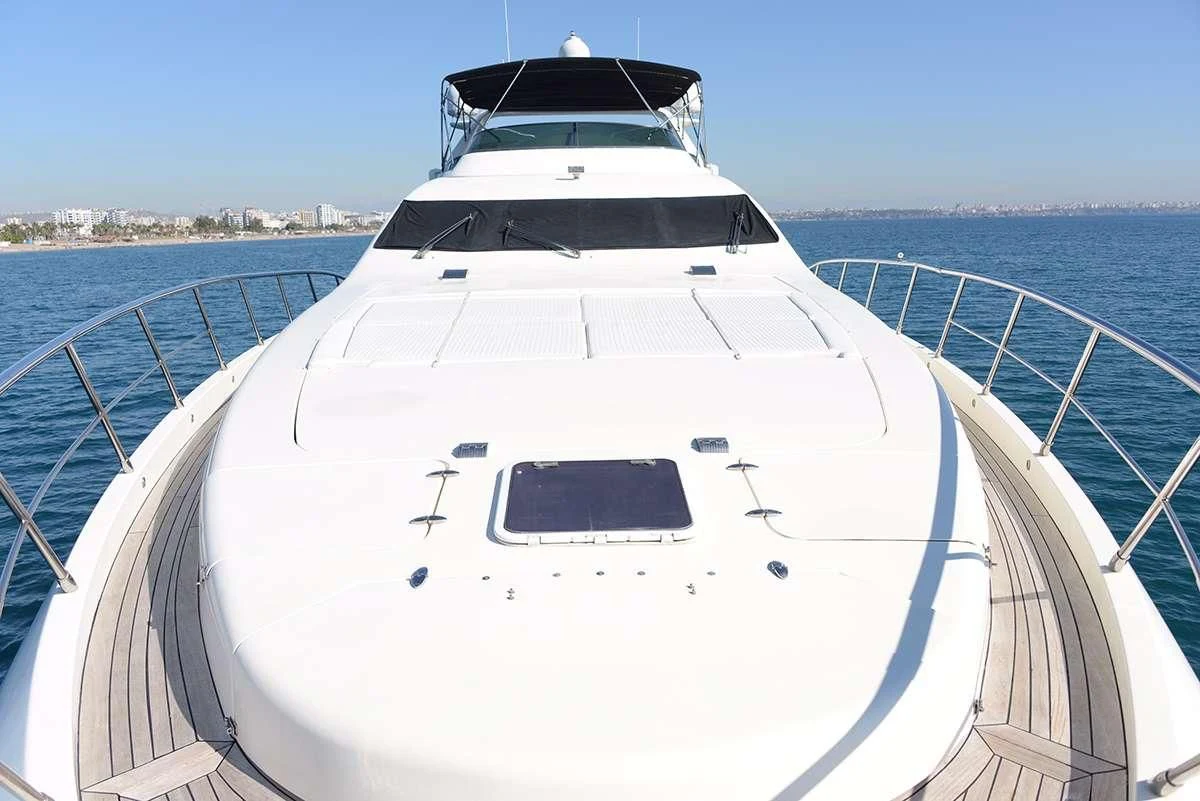 a white yacht on a body of water aboard OBSIDIAN Yacht for Sale
