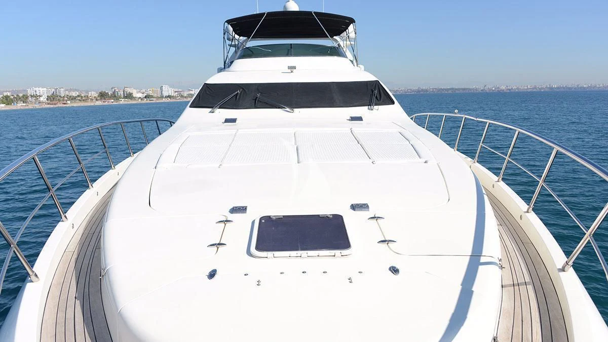 a white yacht on a body of water aboard OBSIDIAN Yacht for Sale