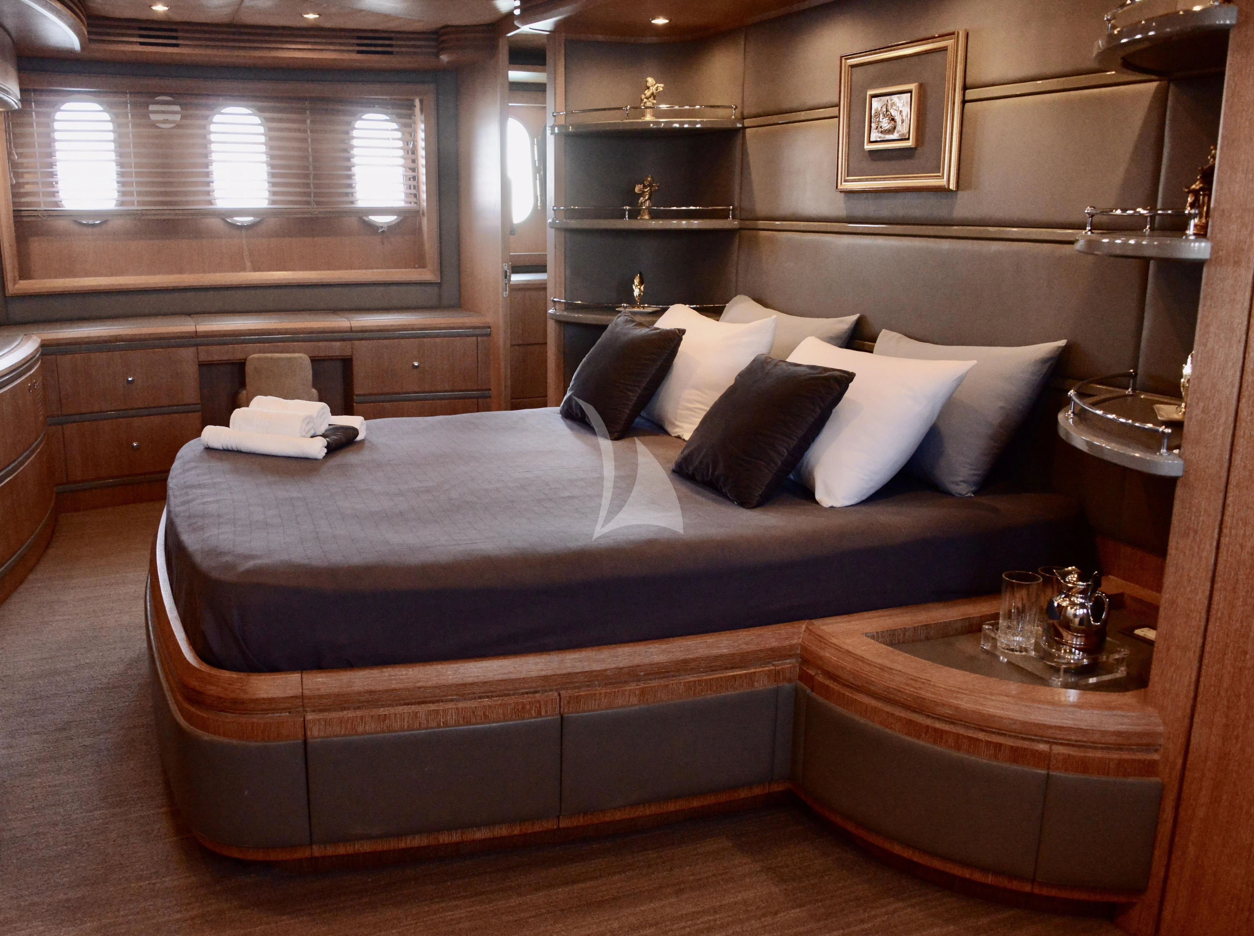 a bed with a black and white bed spread aboard OBSIDIAN Yacht for Sale